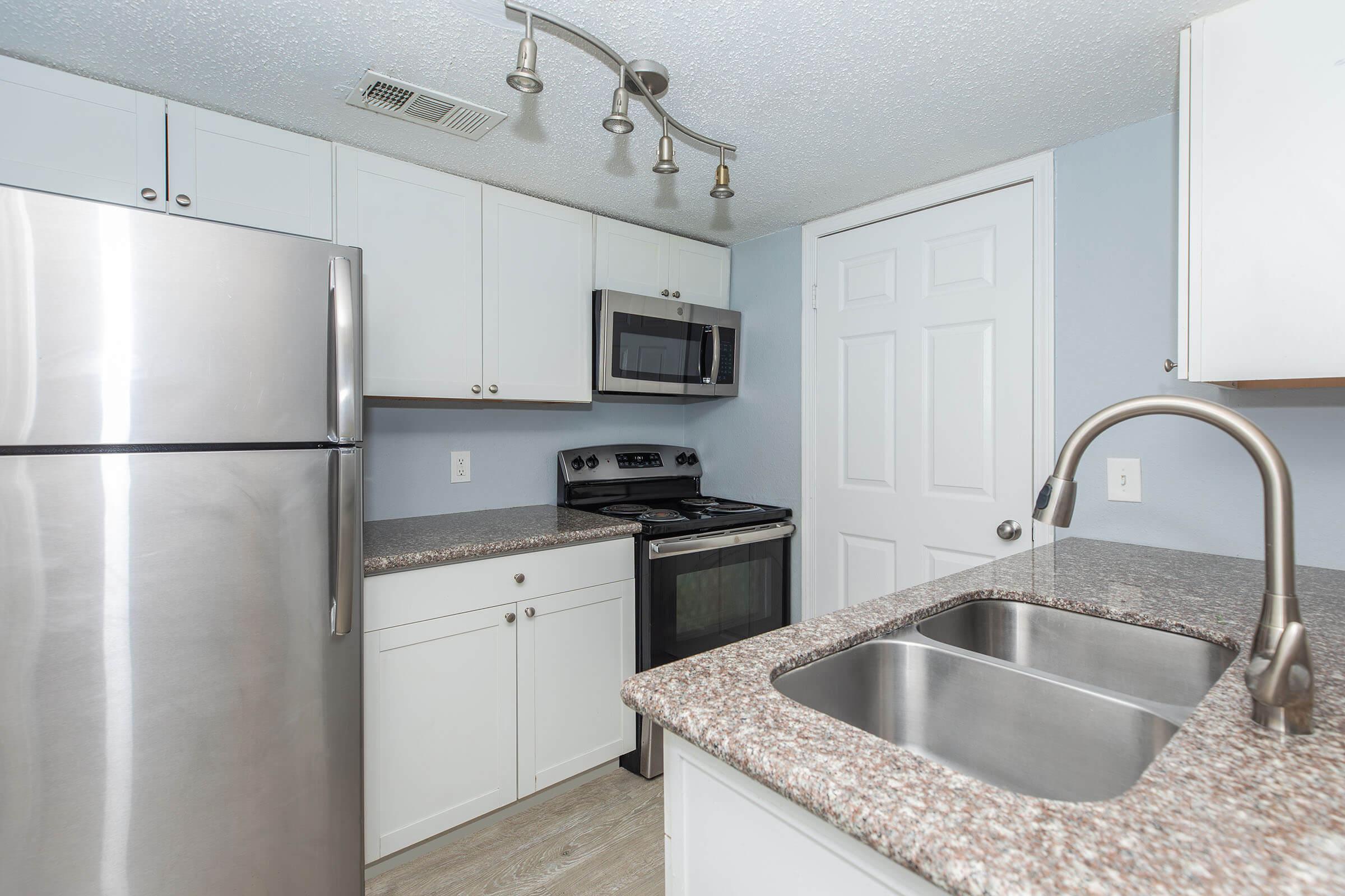 a kitchen with a sink and a refrigerator