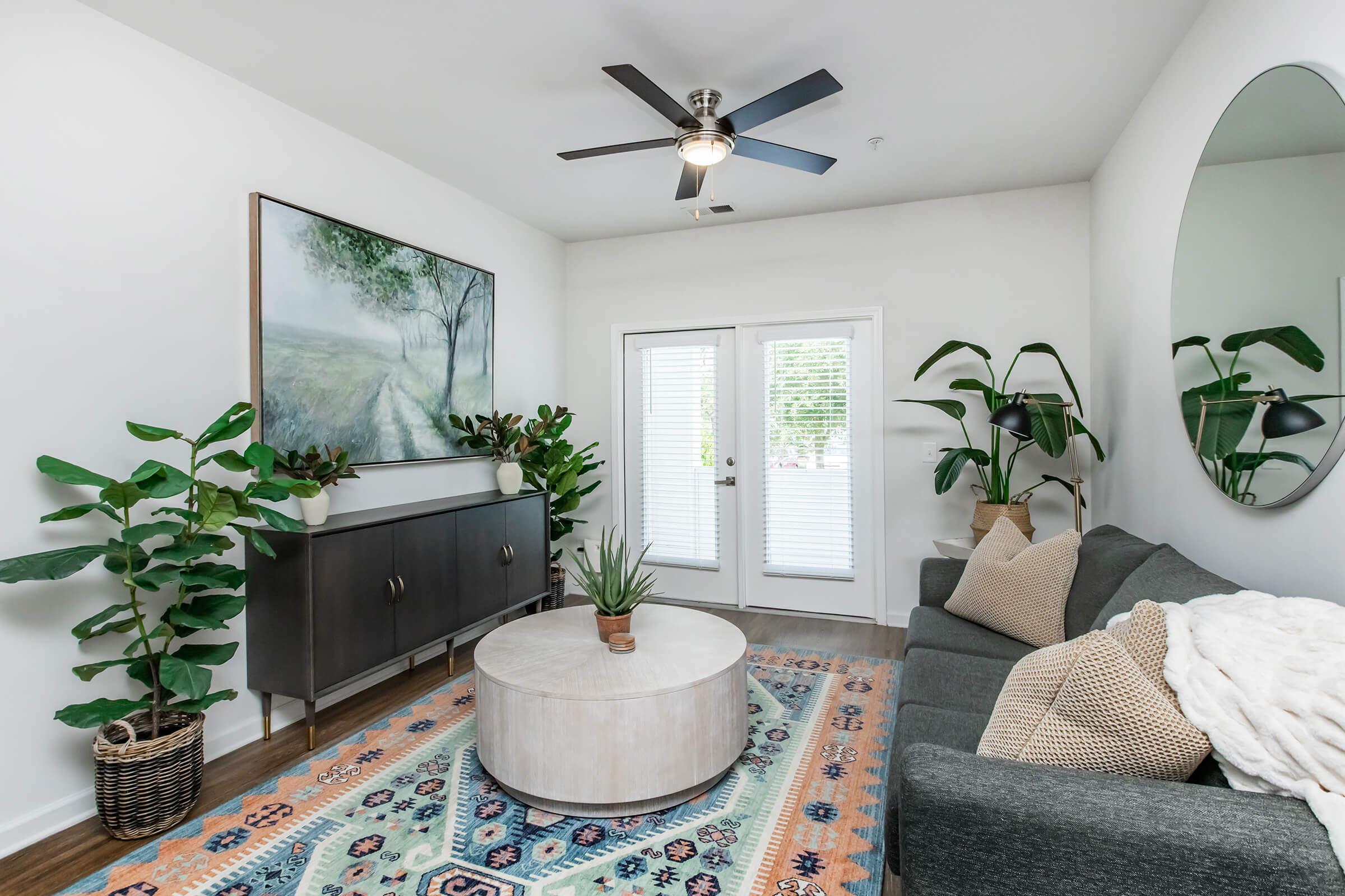 a living room filled with furniture and a large window