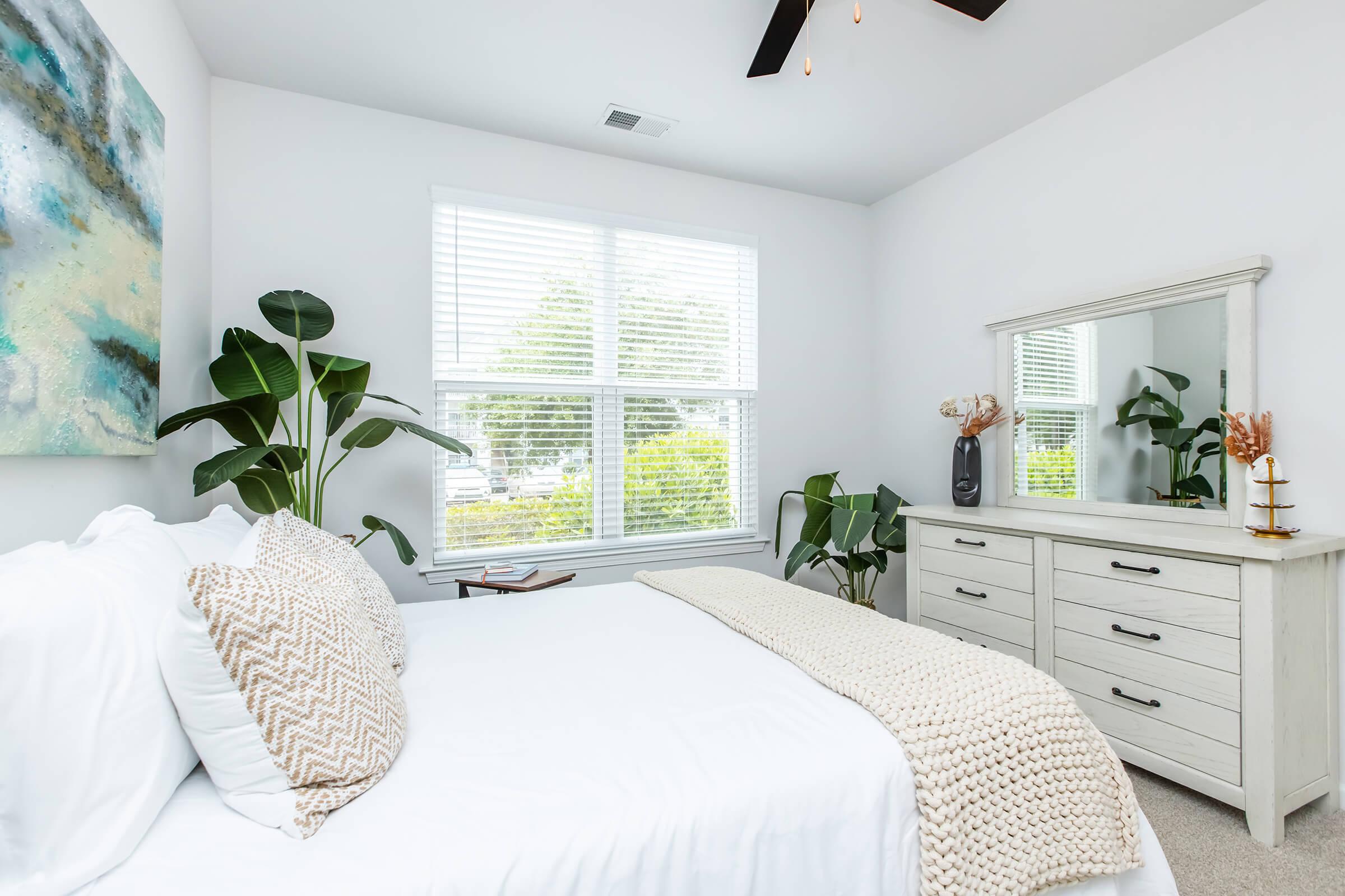 a bedroom with a bed and desk in a room