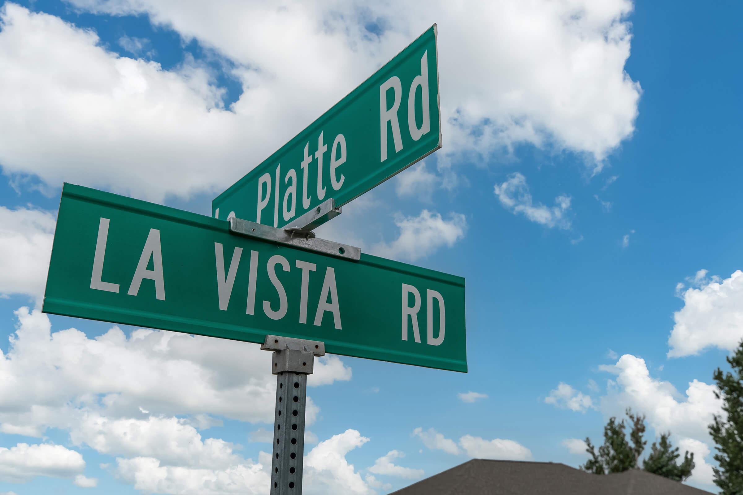 a close up of a couple of street signs on a cloudy day