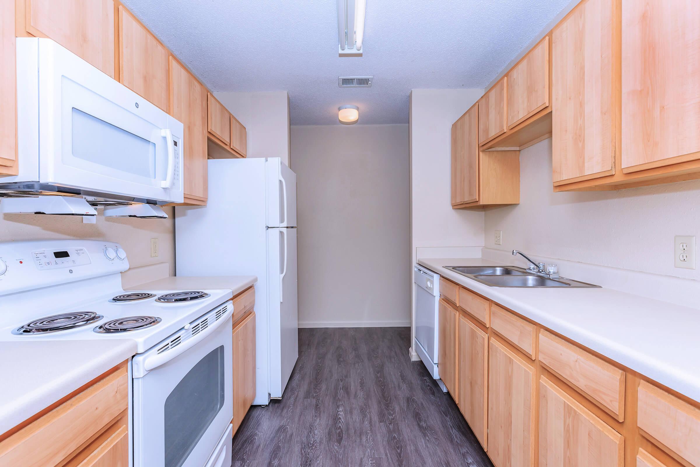 a kitchen with a stove sink and refrigerator