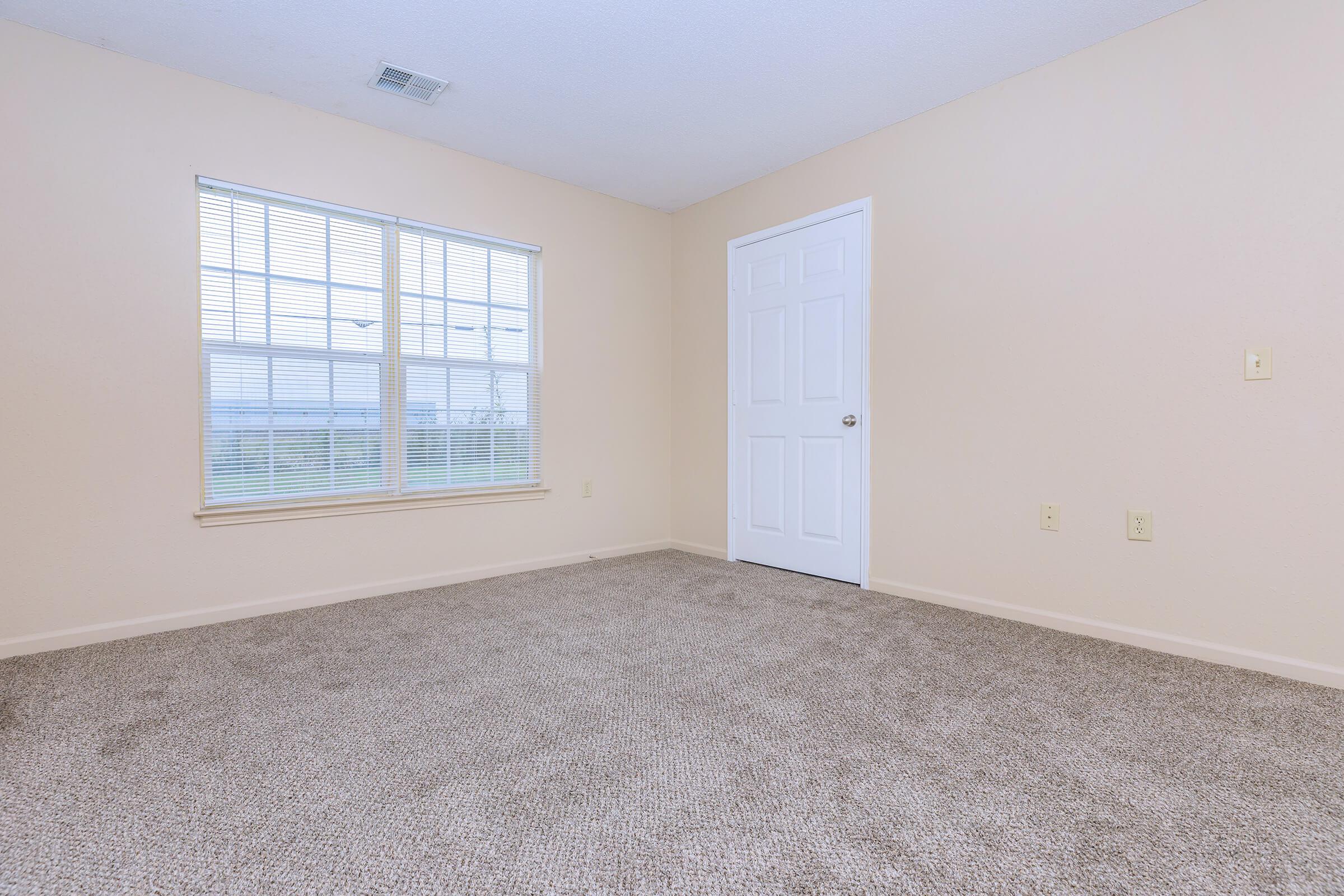 a bedroom with a large window