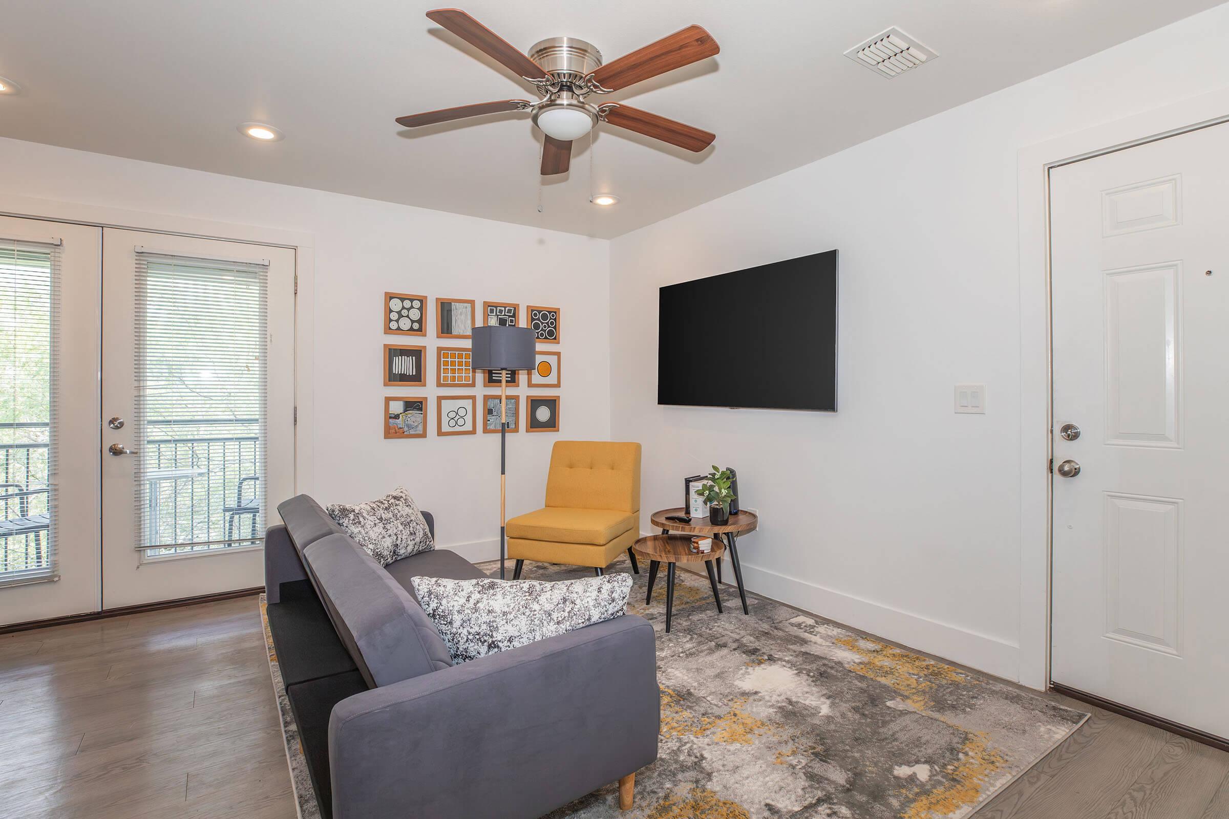 a living room filled with furniture and a large window