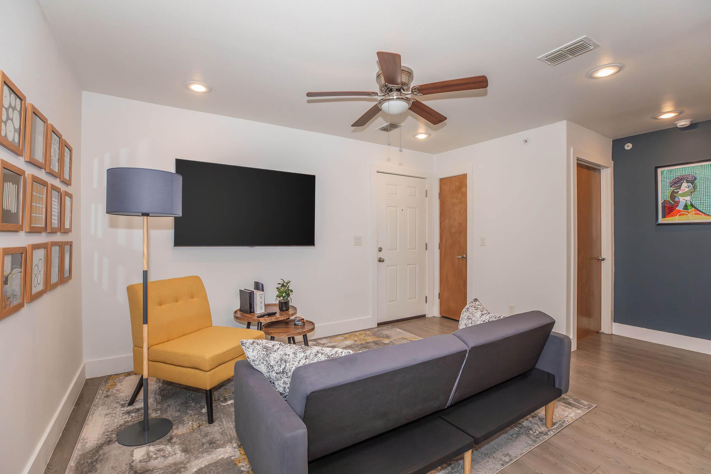 a living room filled with furniture and a flat screen tv