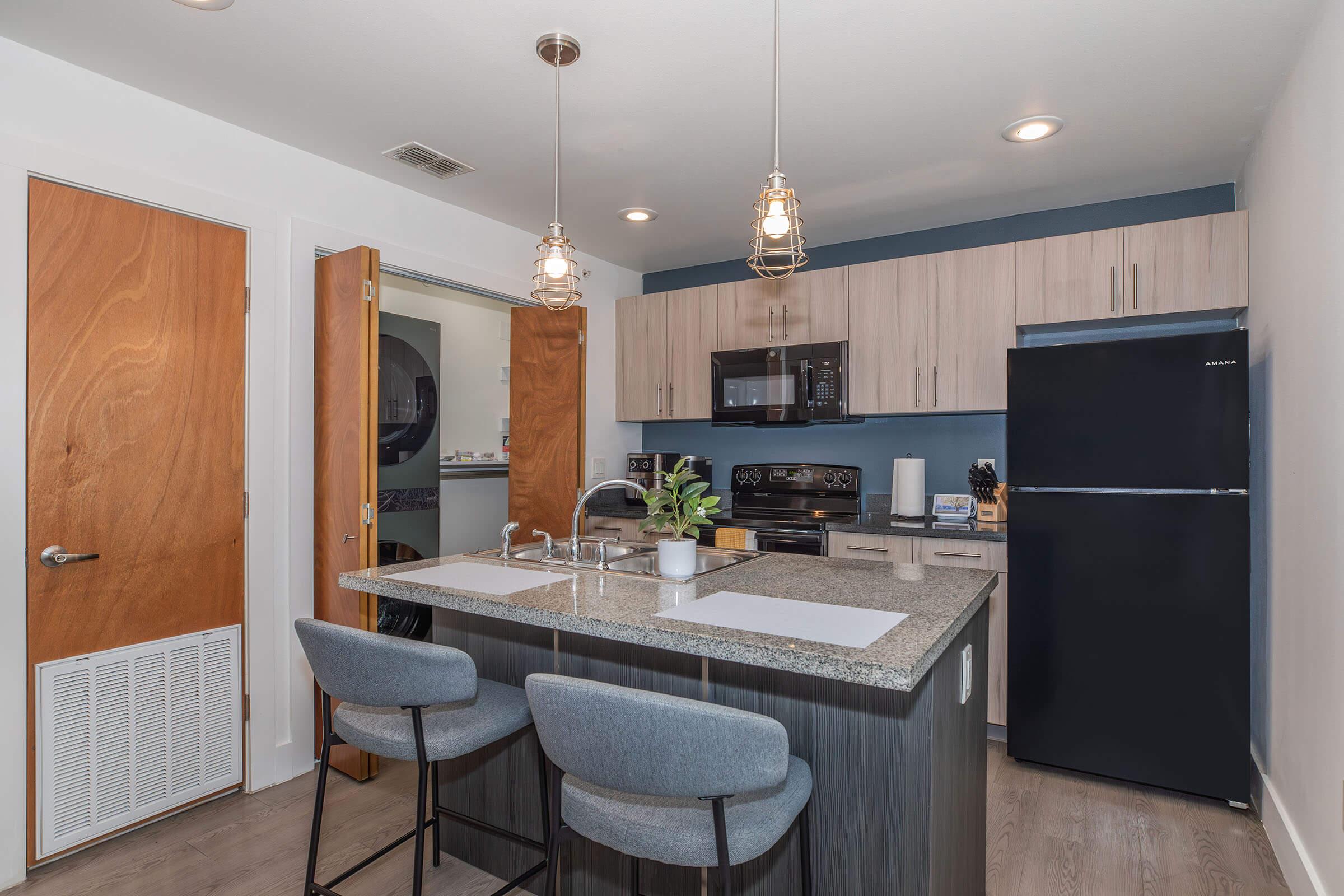 a kitchen with an island in the middle of a room