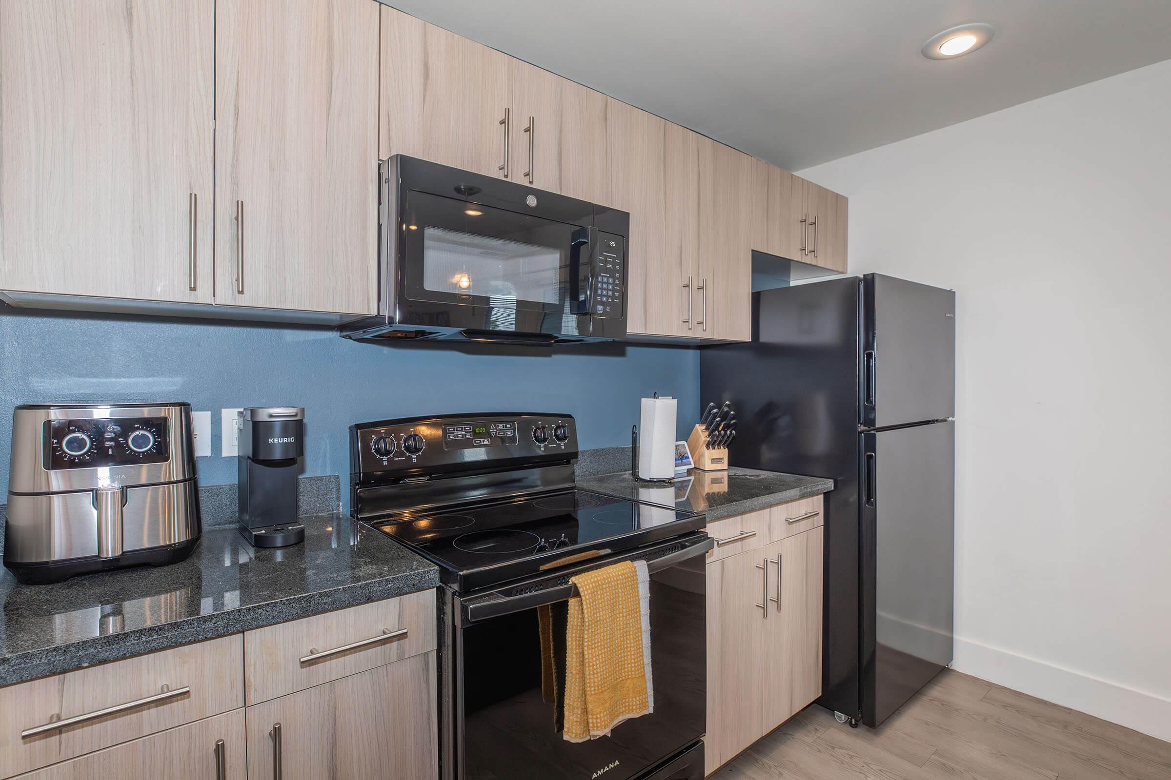 a kitchen with stainless steel appliances and wooden cabinets