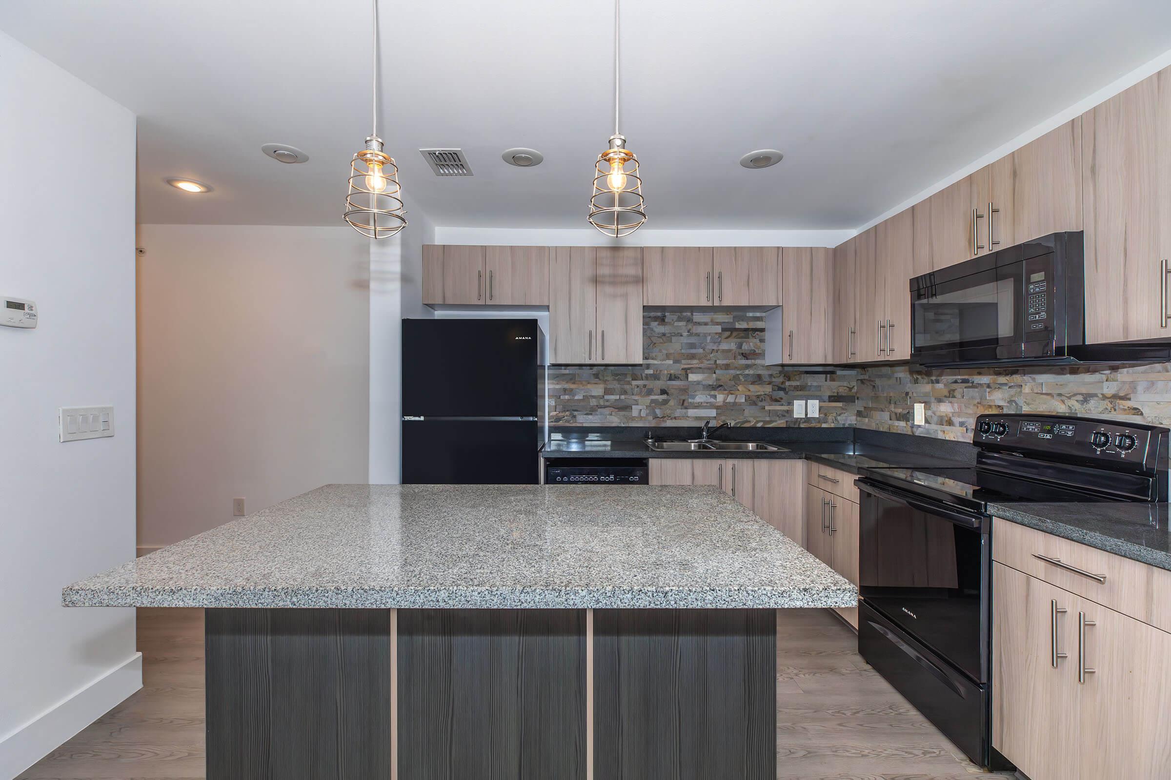 a kitchen with an island in the middle of a room