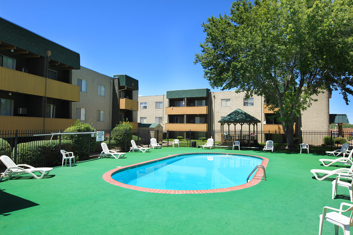 a large lawn in front of a pool