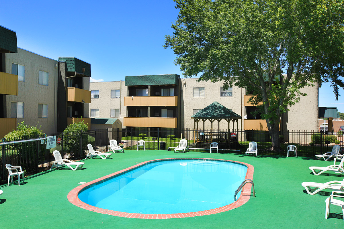 a large lawn in front of a pool