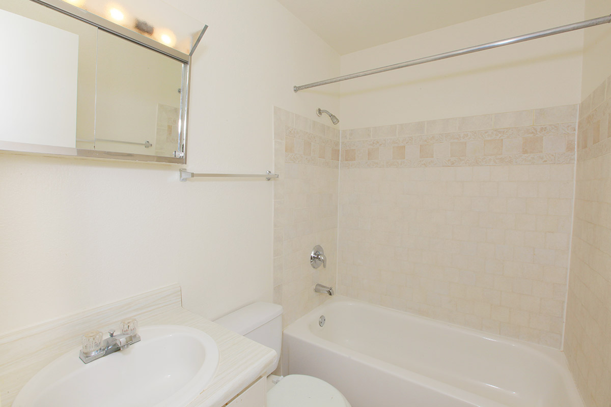 a white tub sitting next to a sink