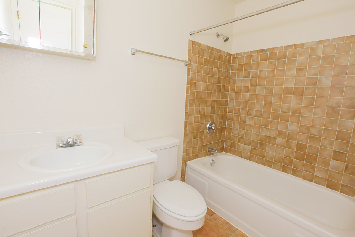 a white tub sitting next to a sink