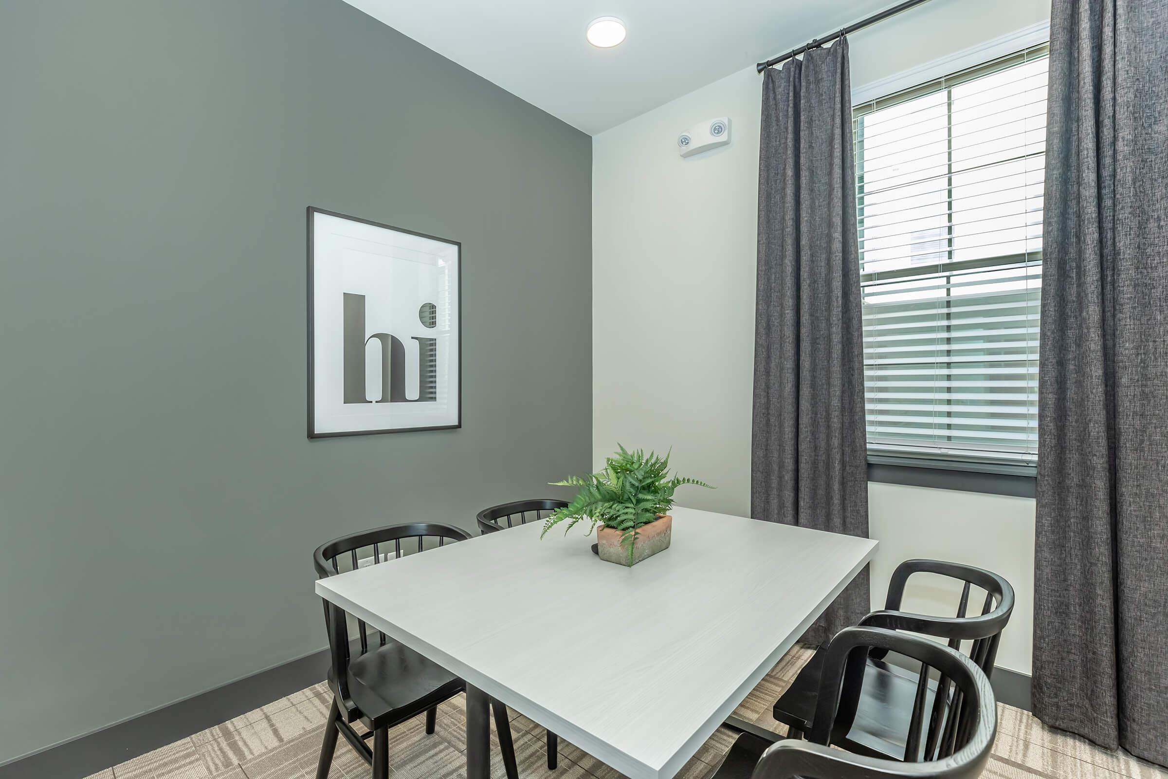 a living room with a table in front of a window