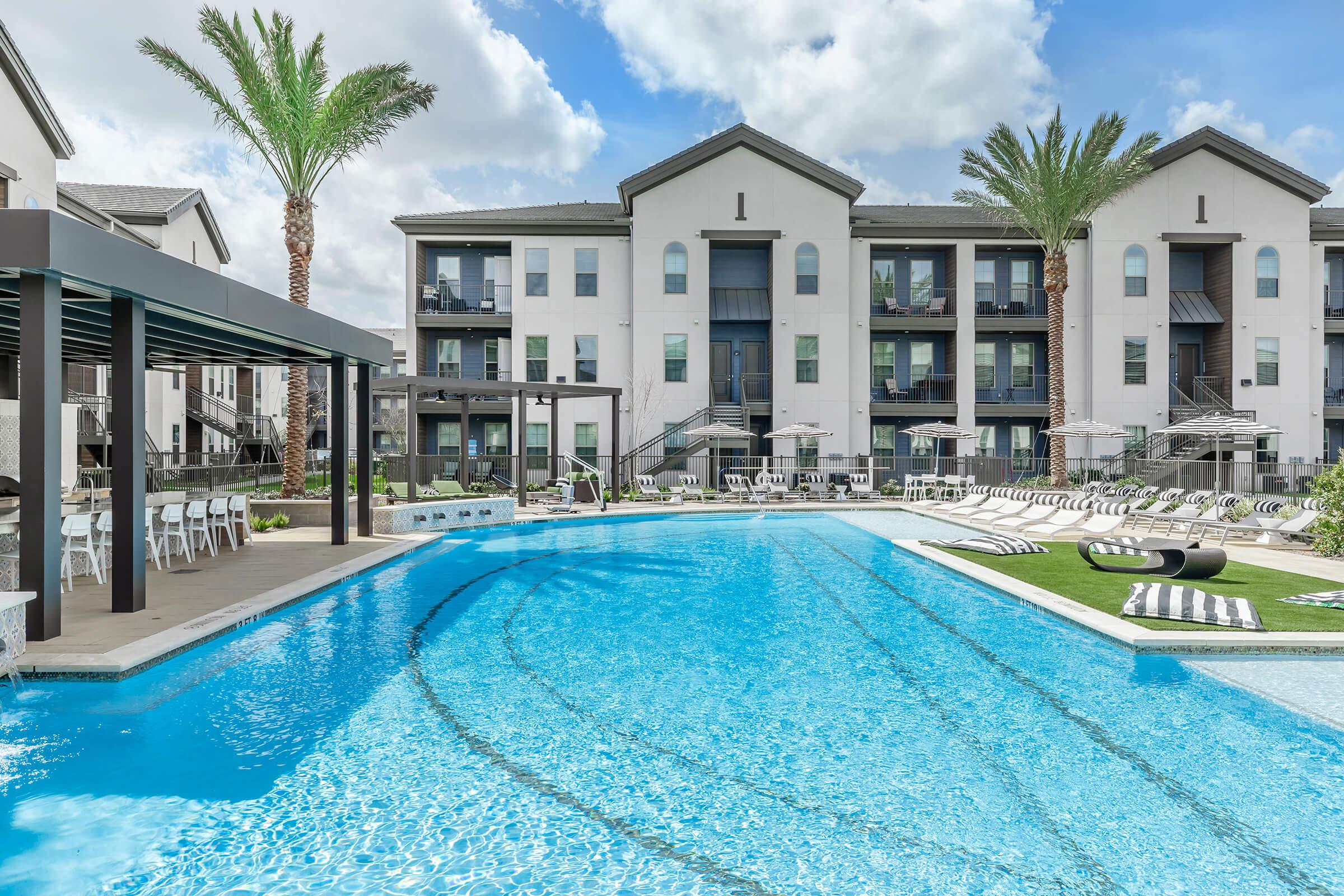 a house with a pool in front of a building