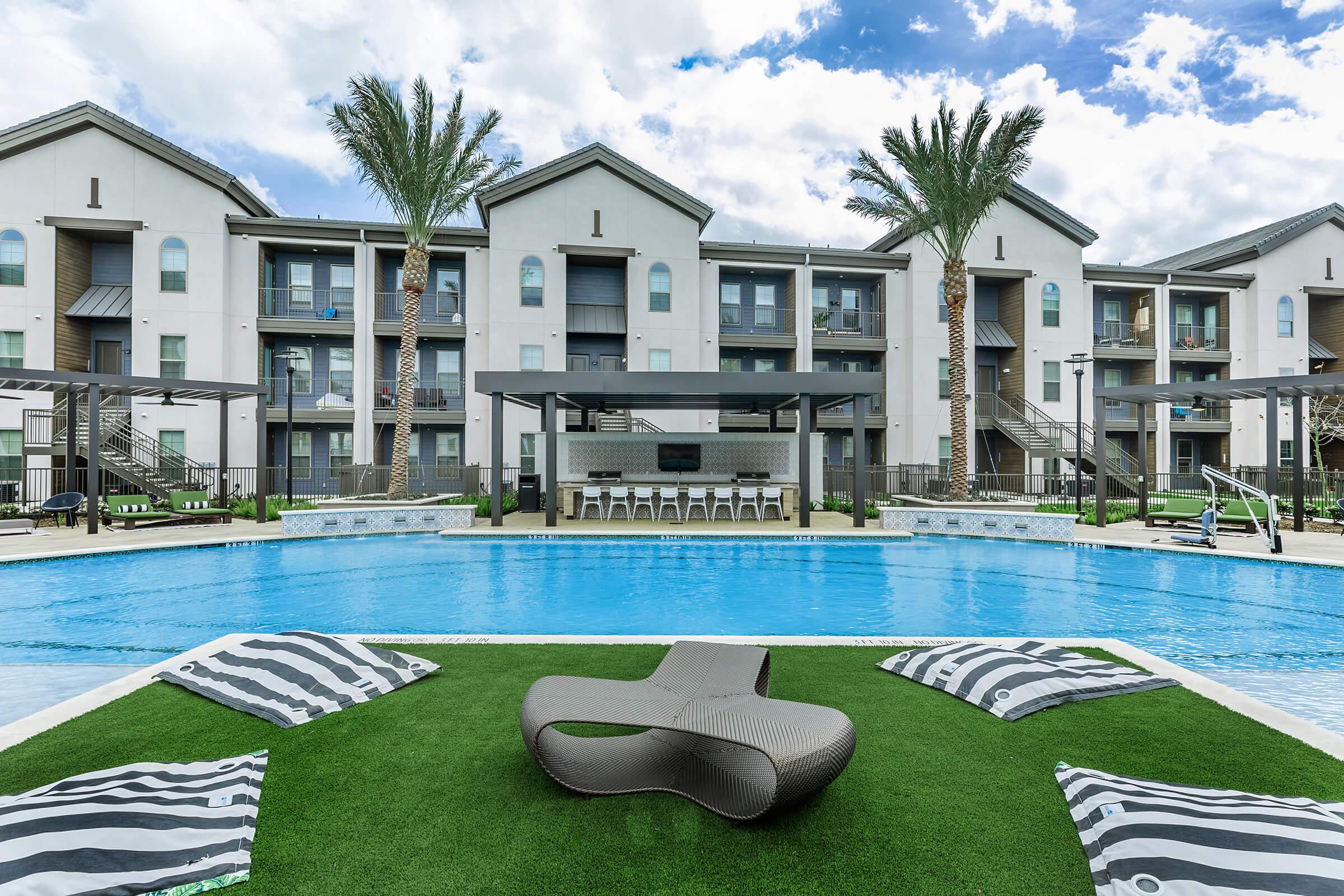 a house with a pool in front of a building