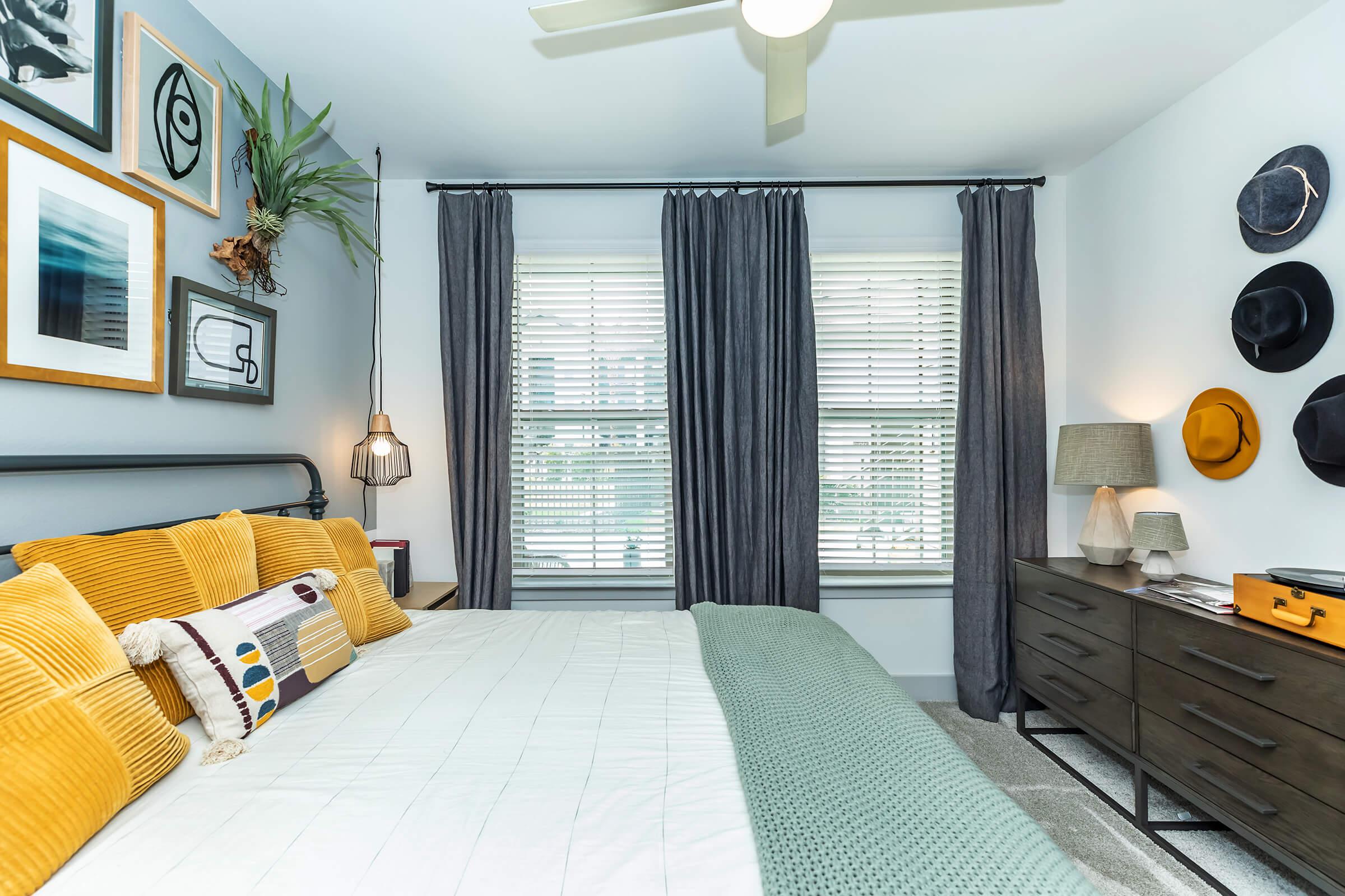 a bedroom with a bed and desk in a room