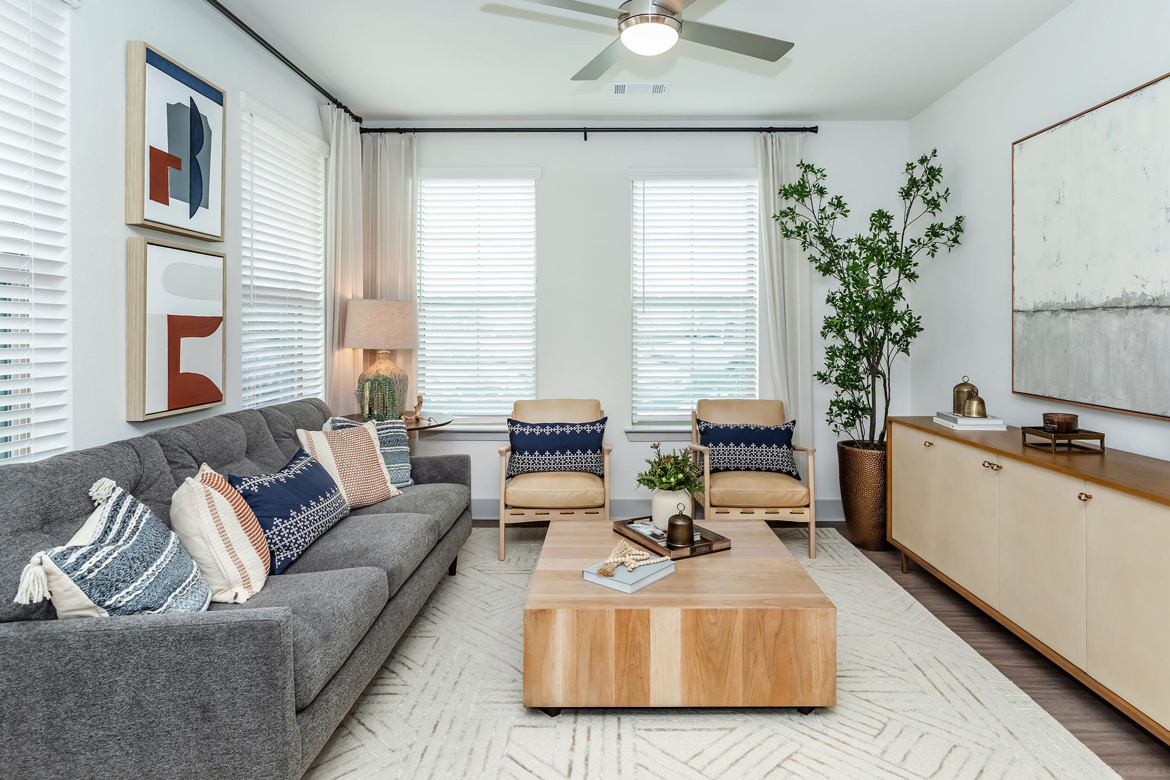 a living room filled with furniture and a large window