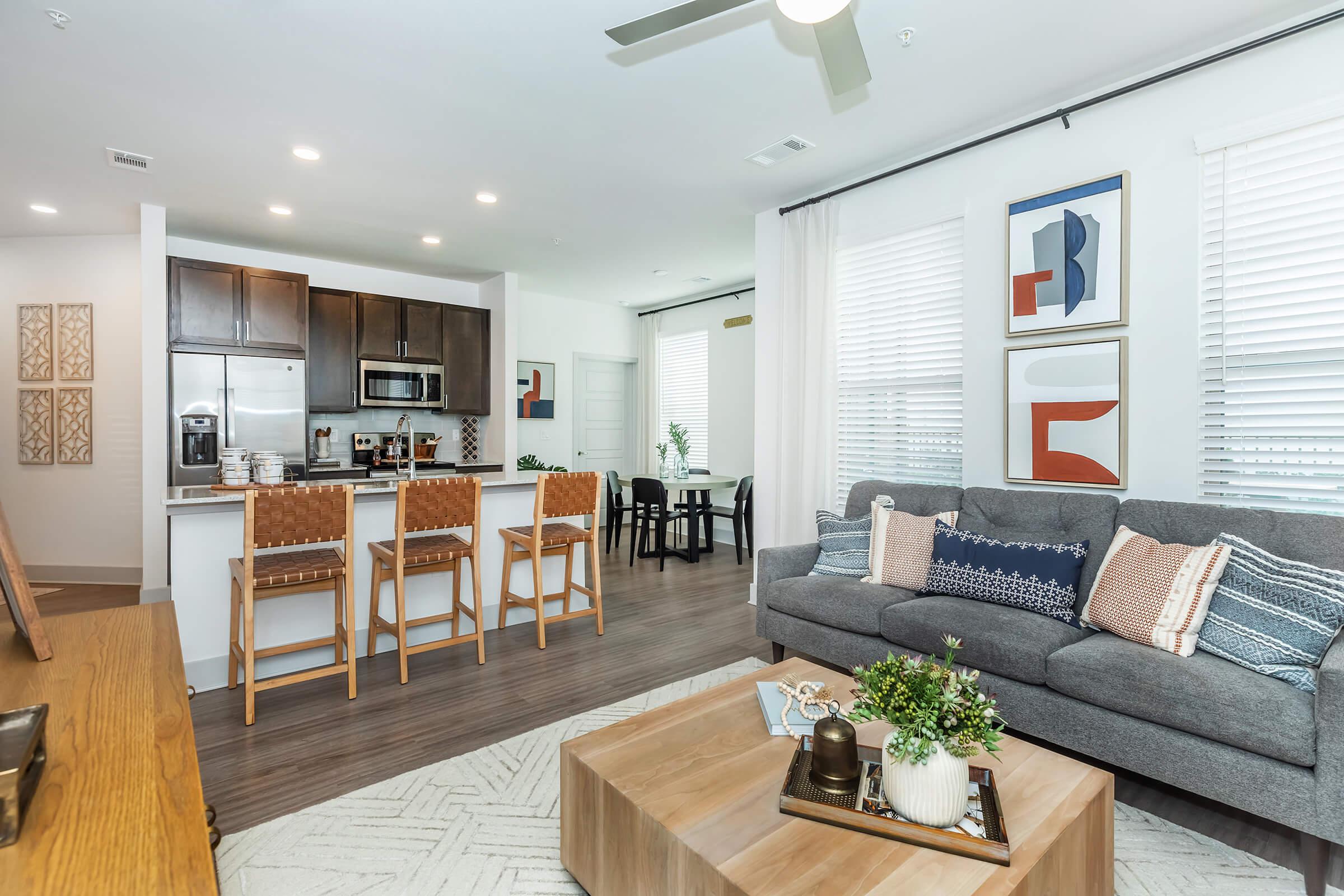 a living room filled with furniture and a large window