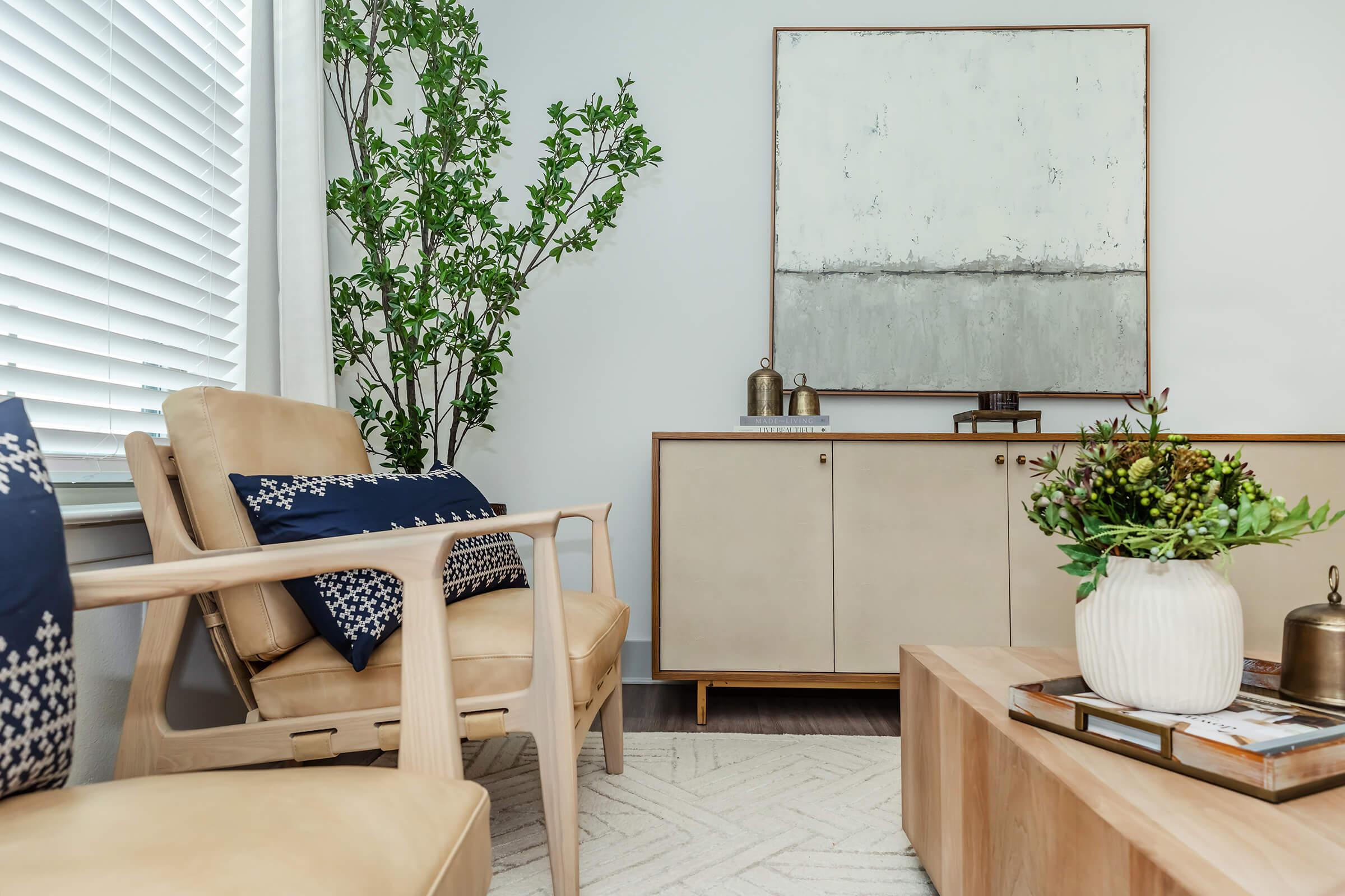 a room filled with furniture and vase of flowers on a table