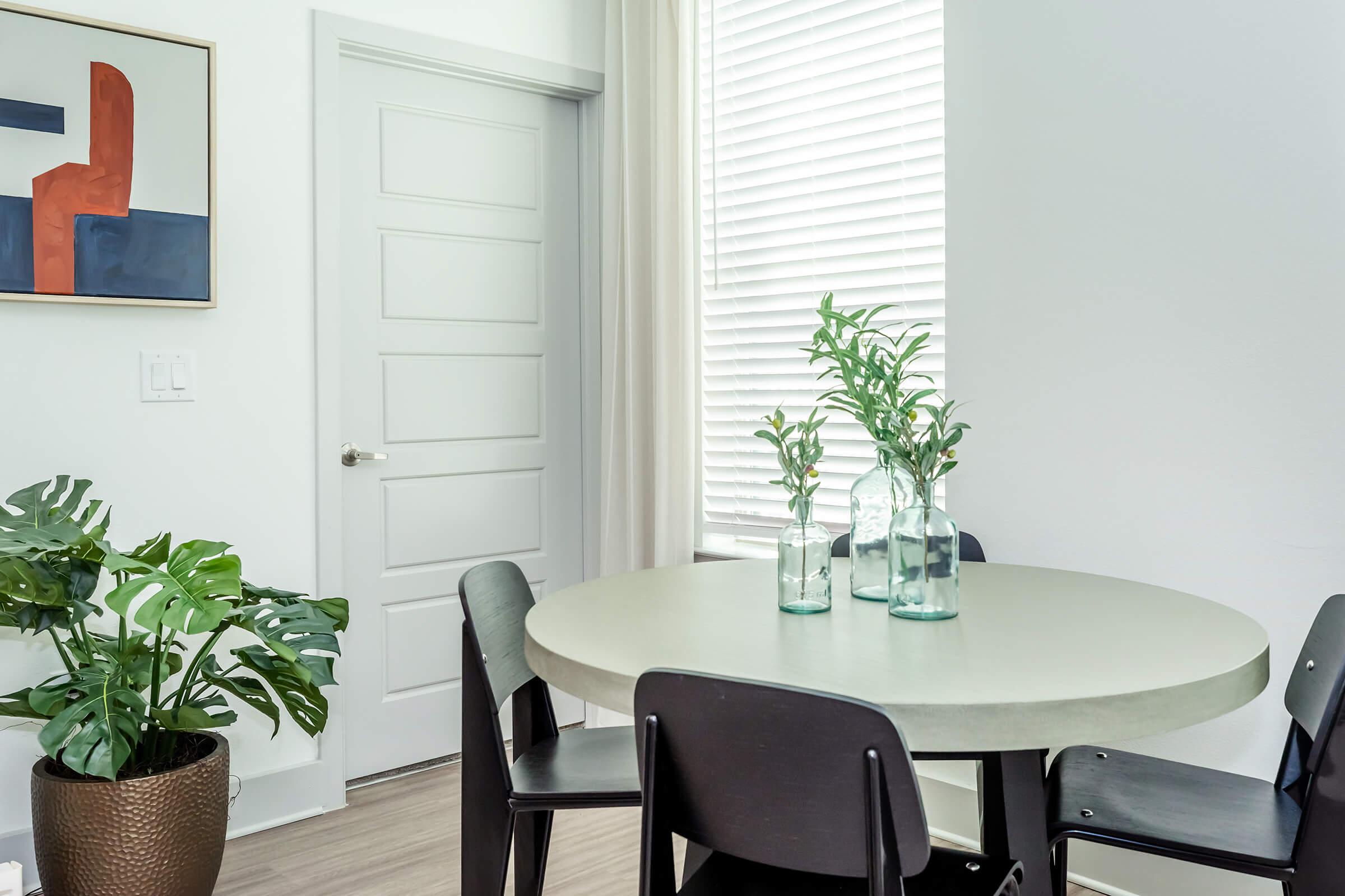 a dining room table in front of a window