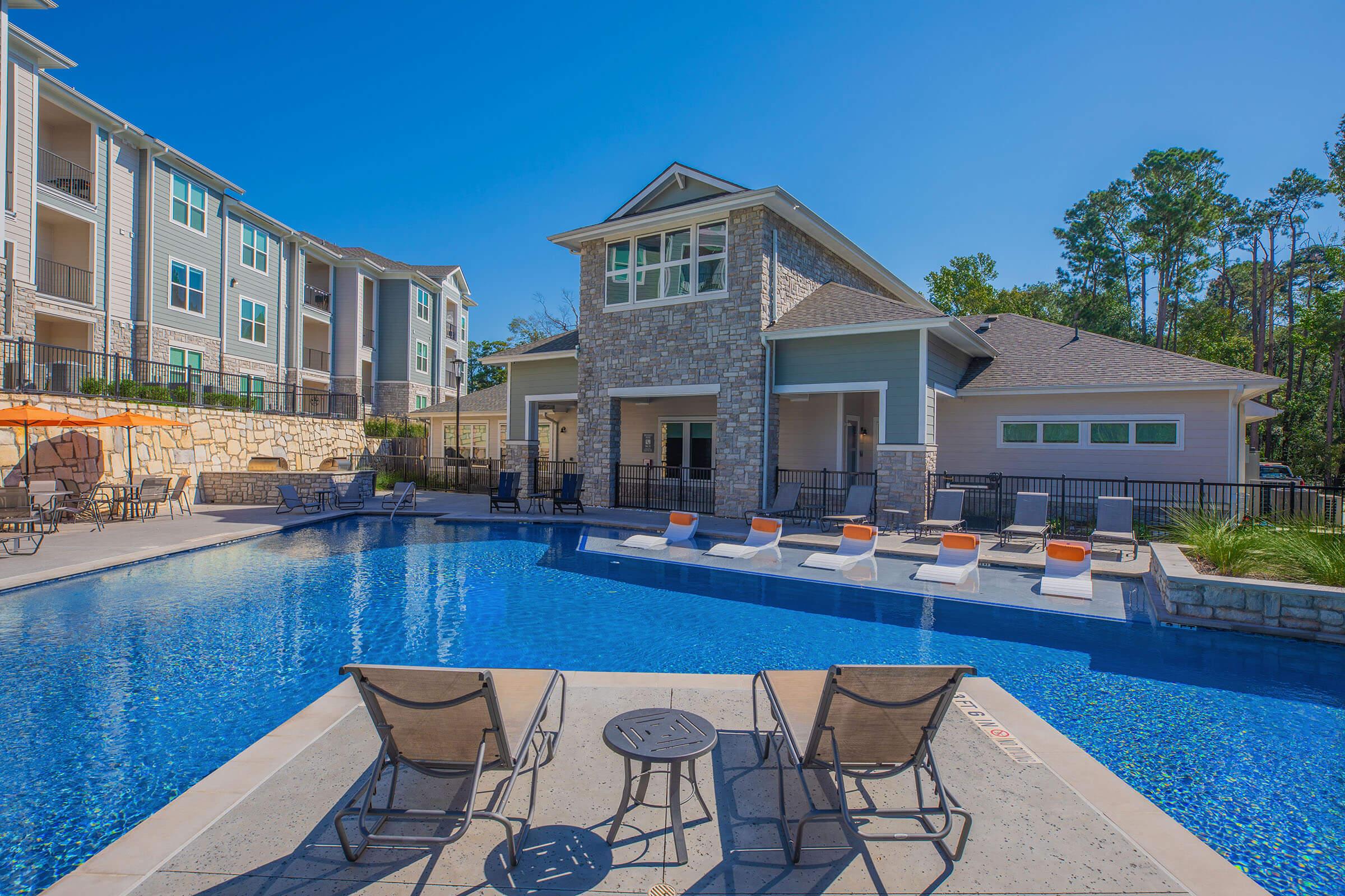 a blue pool of water in front of a building