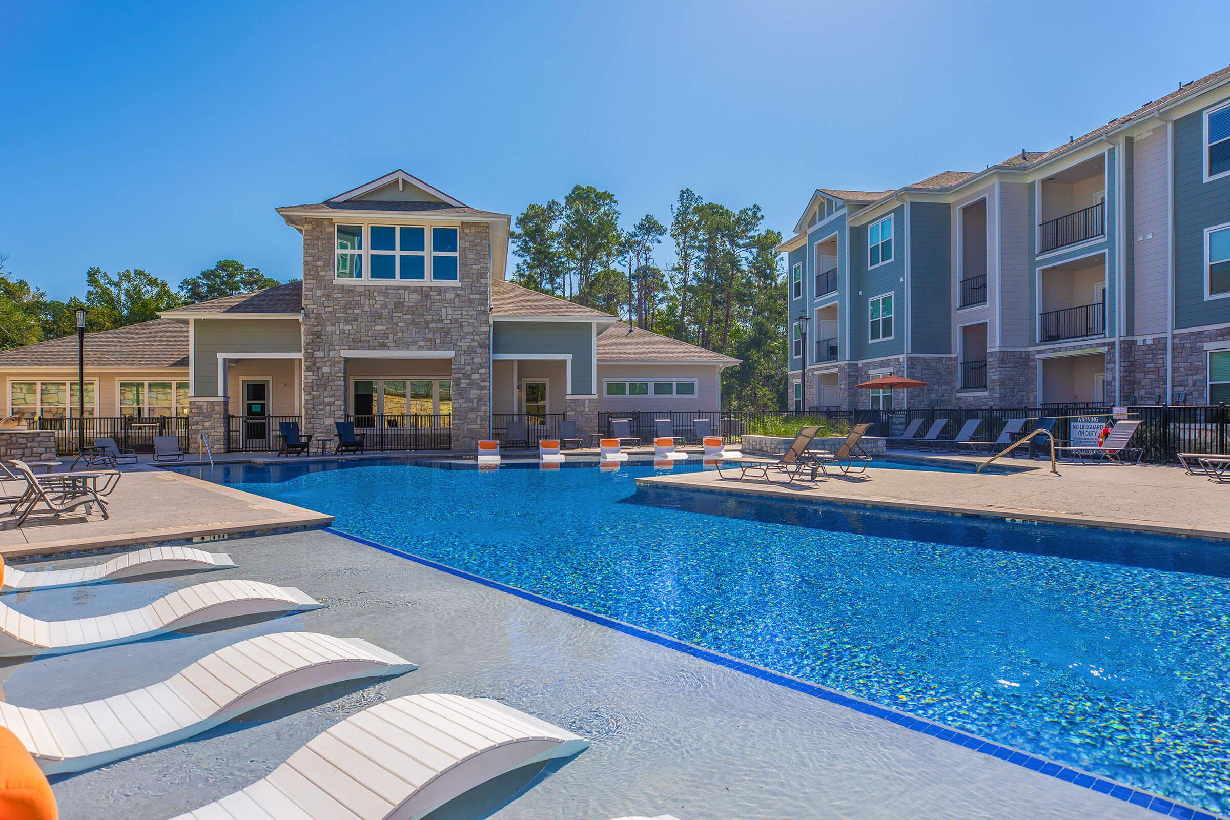 a house with a pool in front of a building