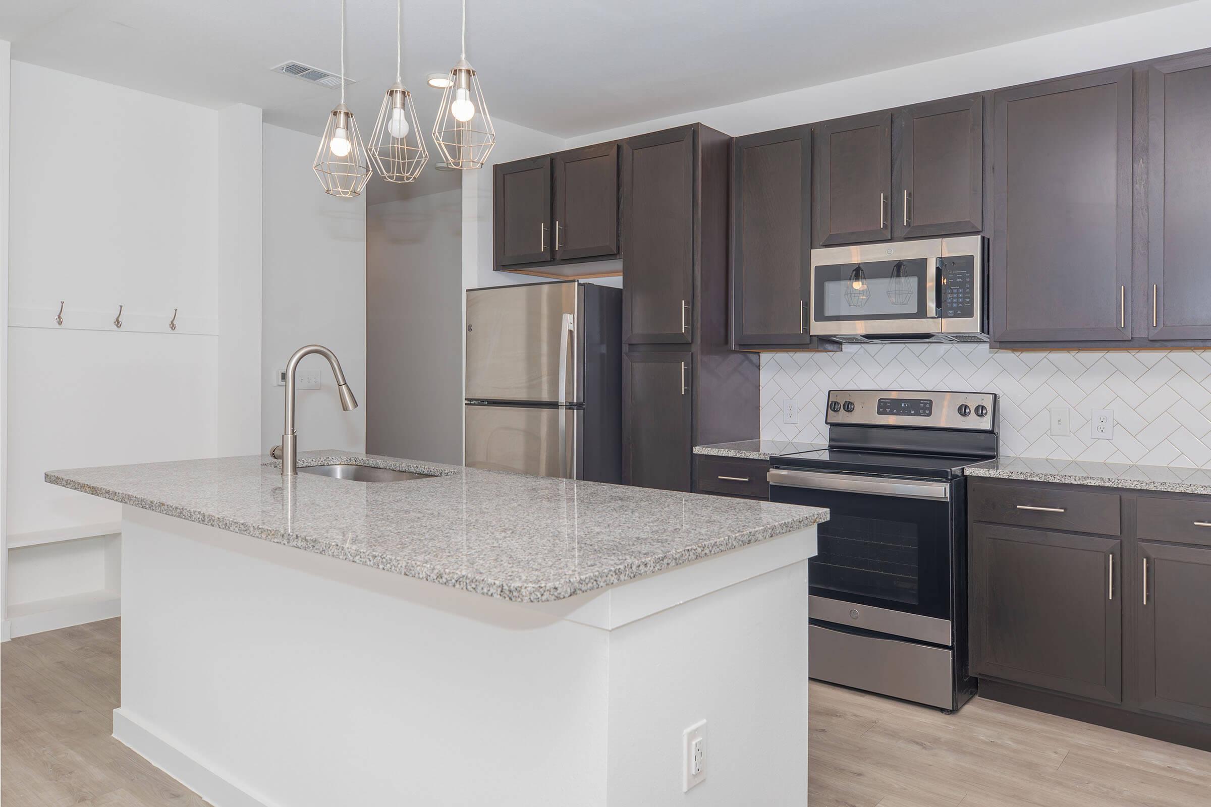 a kitchen with a sink and a mirror