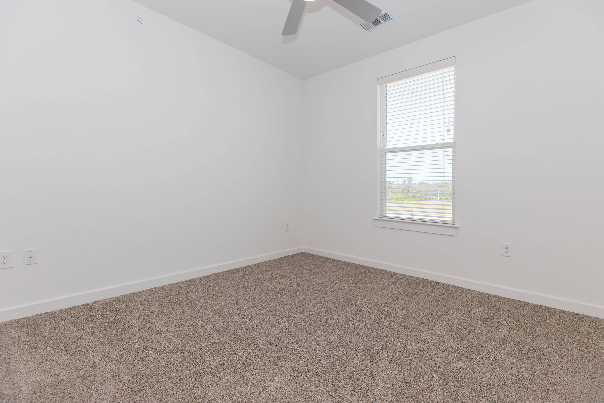 a bedroom with a large window