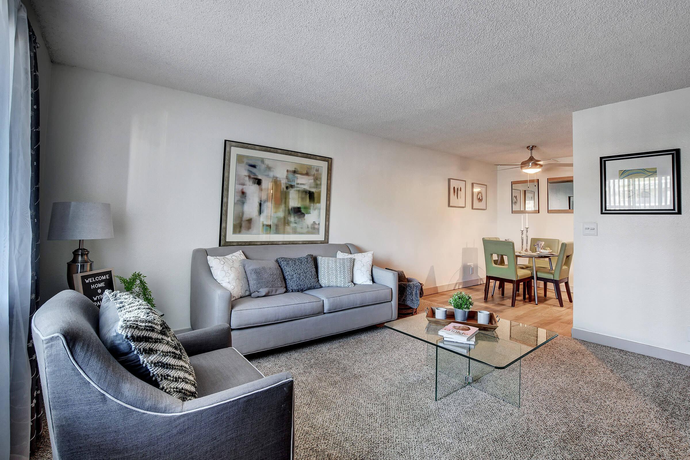 a living room filled with furniture and a rug