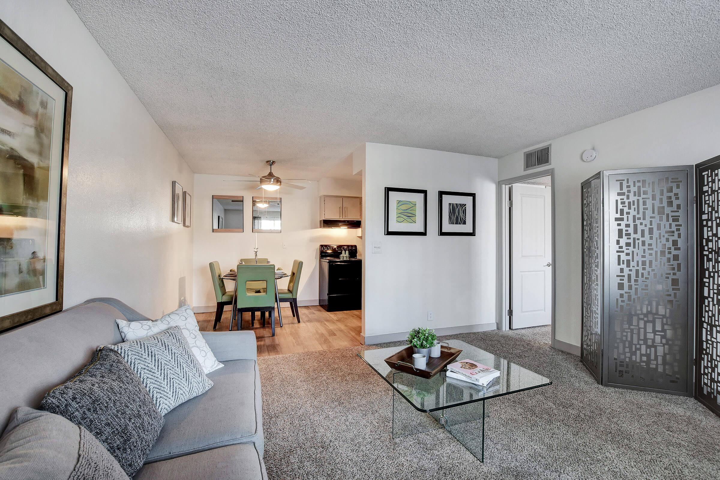 a living room filled with furniture and a bed