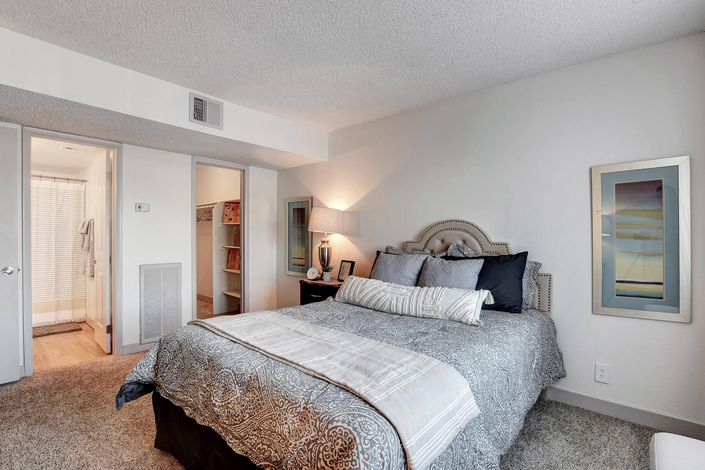 a bedroom with a large bed in a room