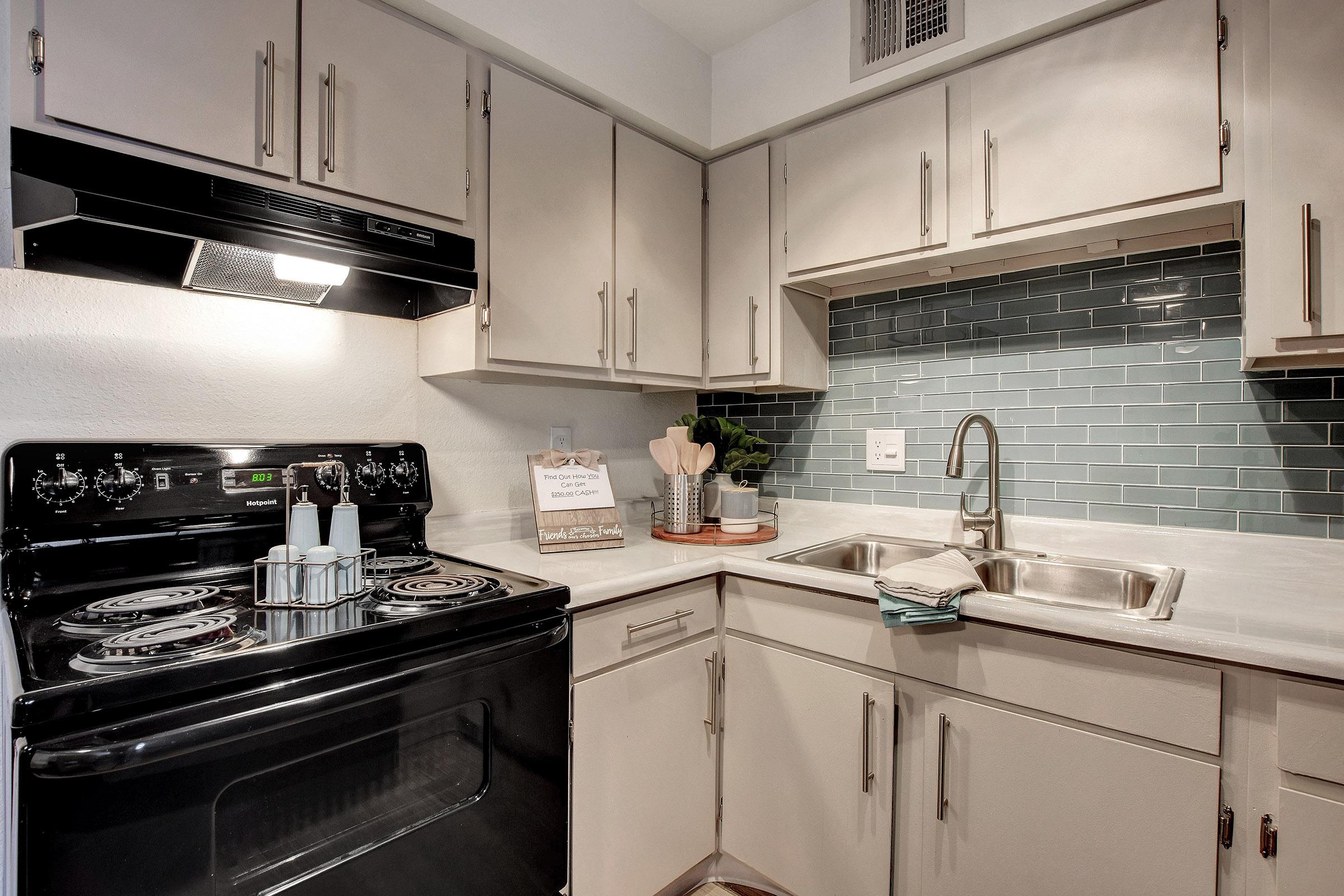 a kitchen with a stove and a sink