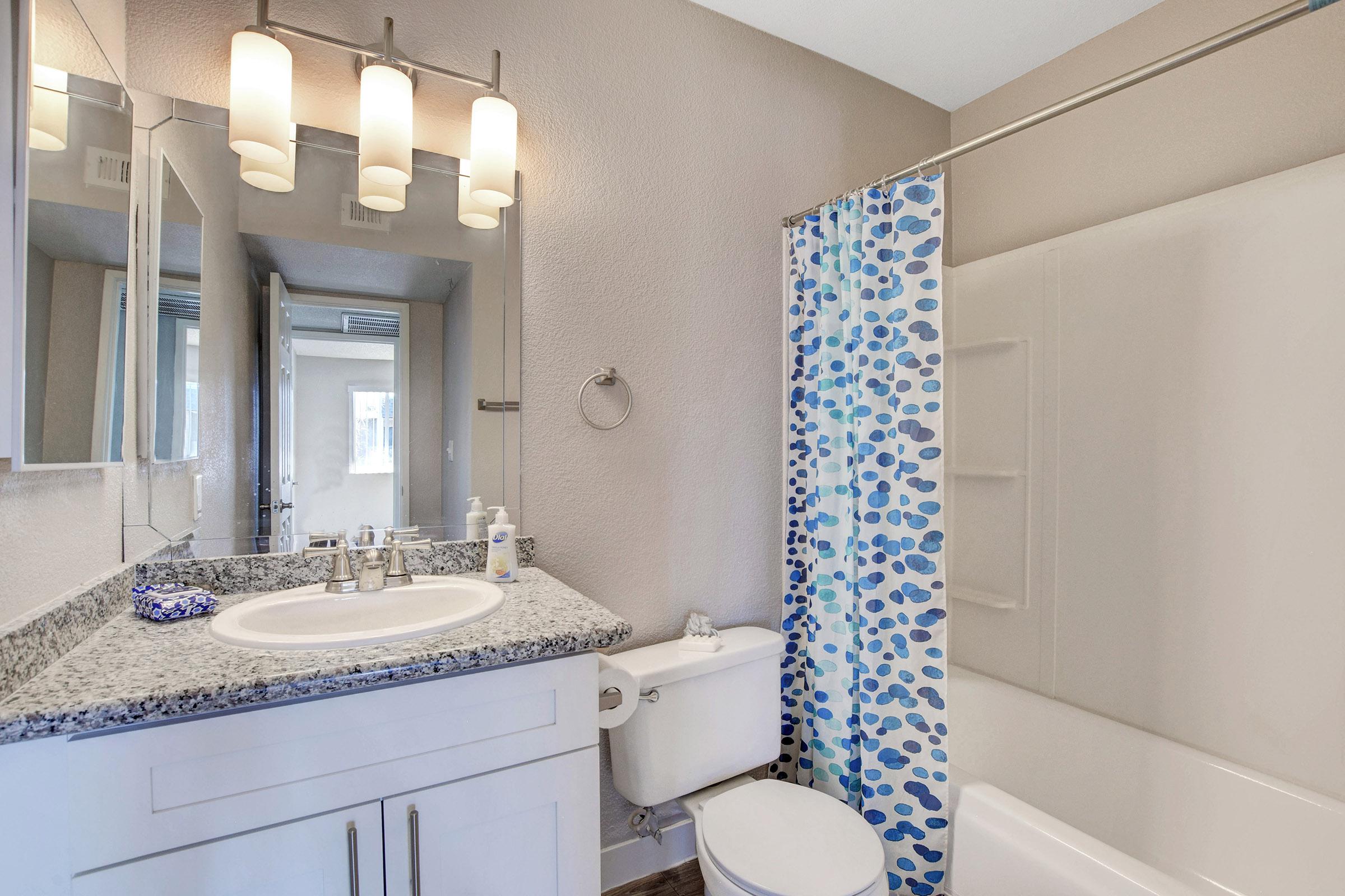 a white sink and a mirror