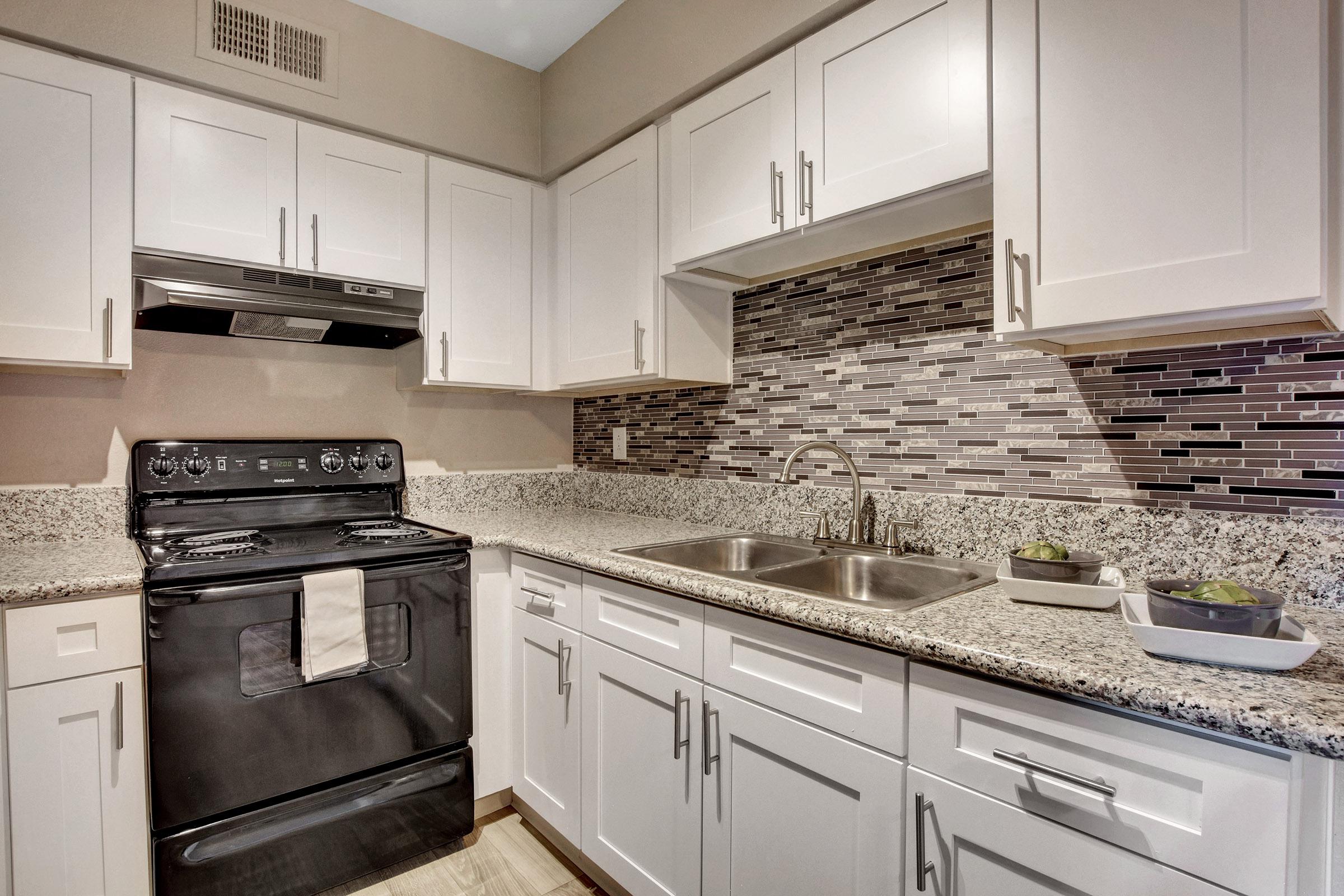 a kitchen with a stove and a sink