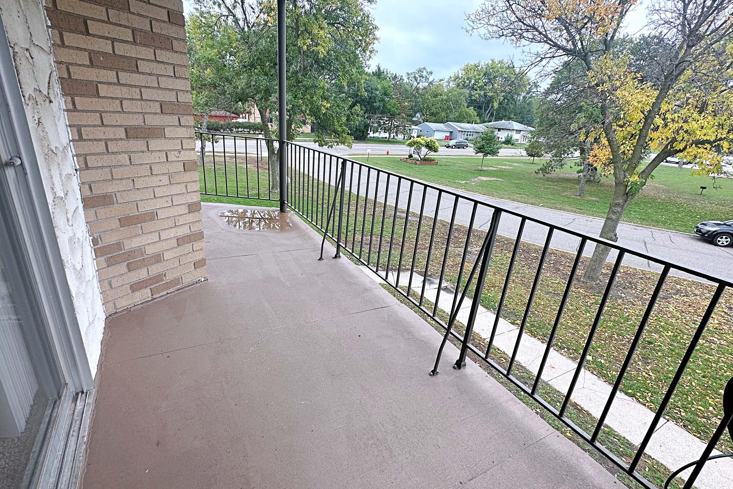 a path with trees on the side of a fence