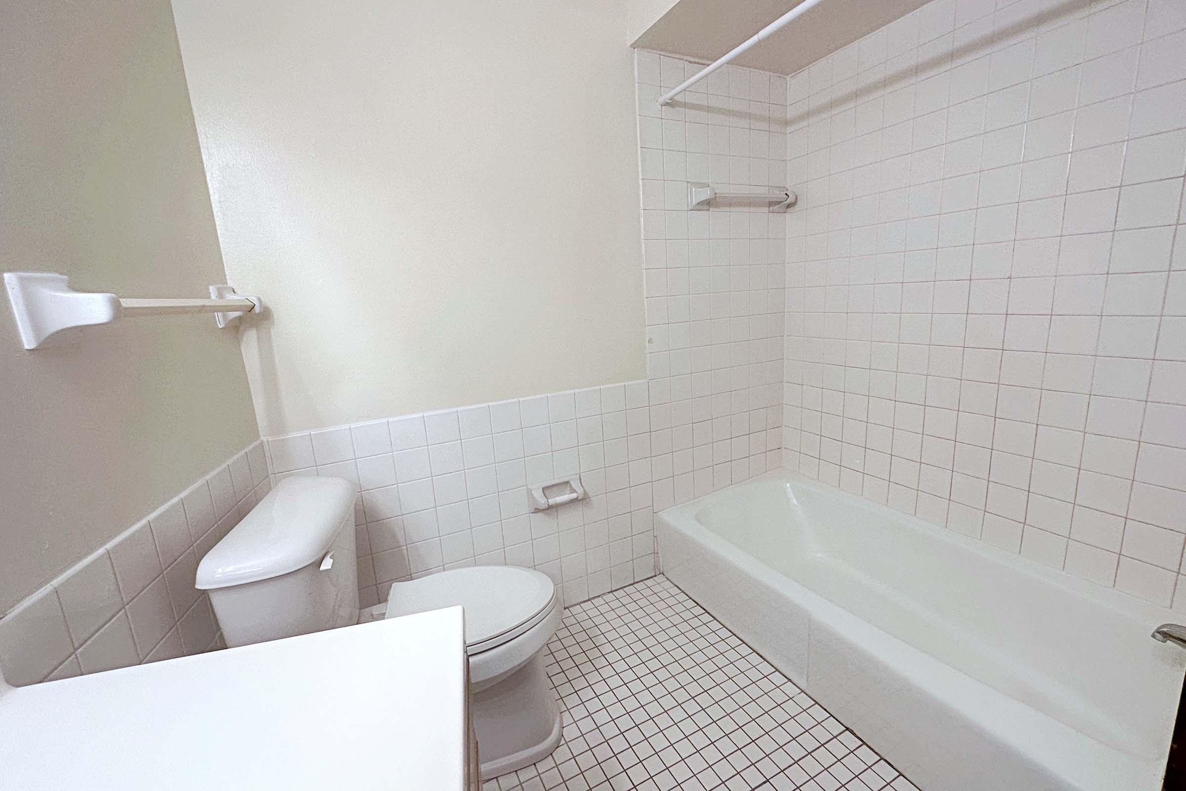 a close up of pink tub and sink