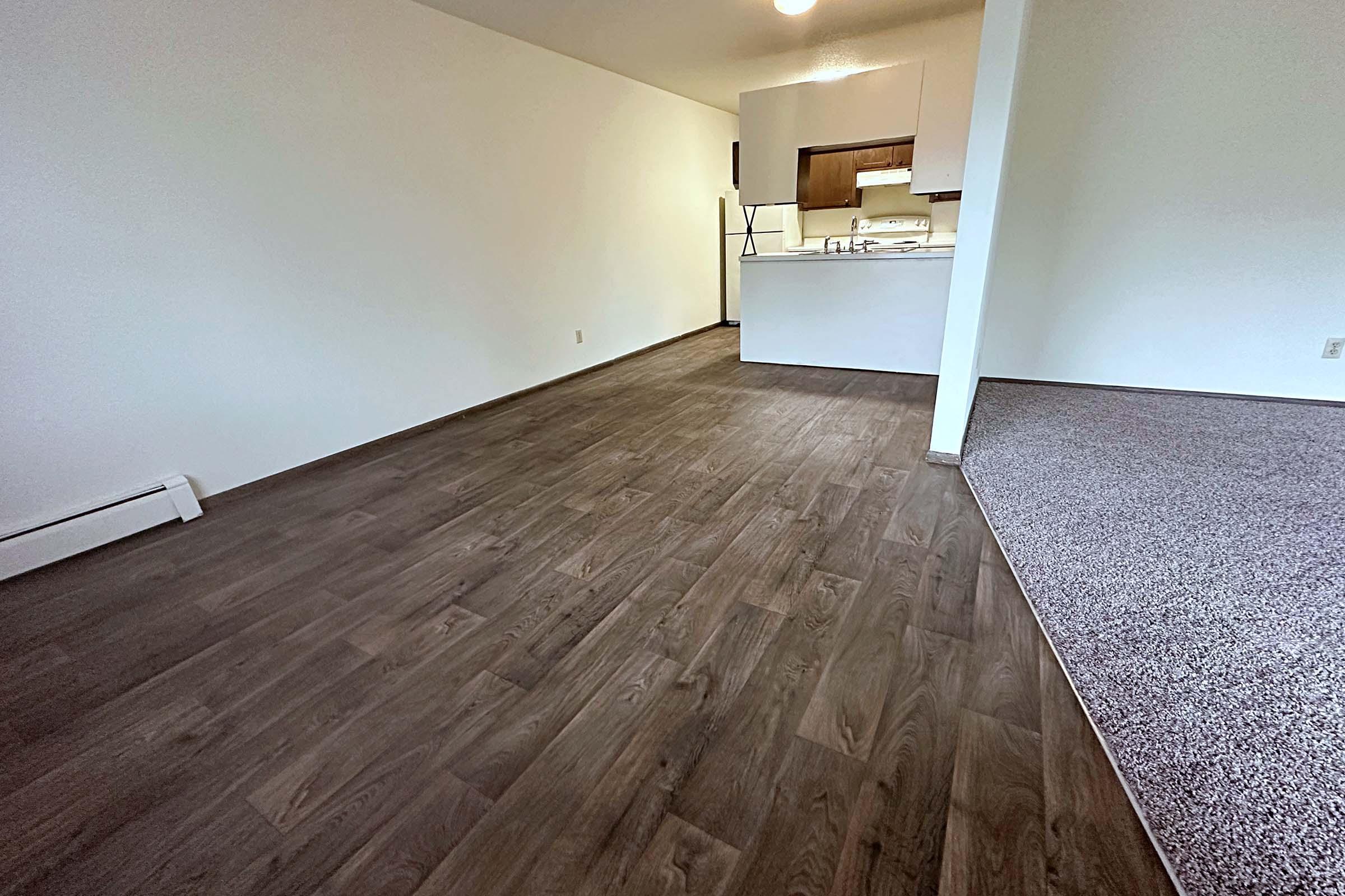 a large empty room with a wooden floor