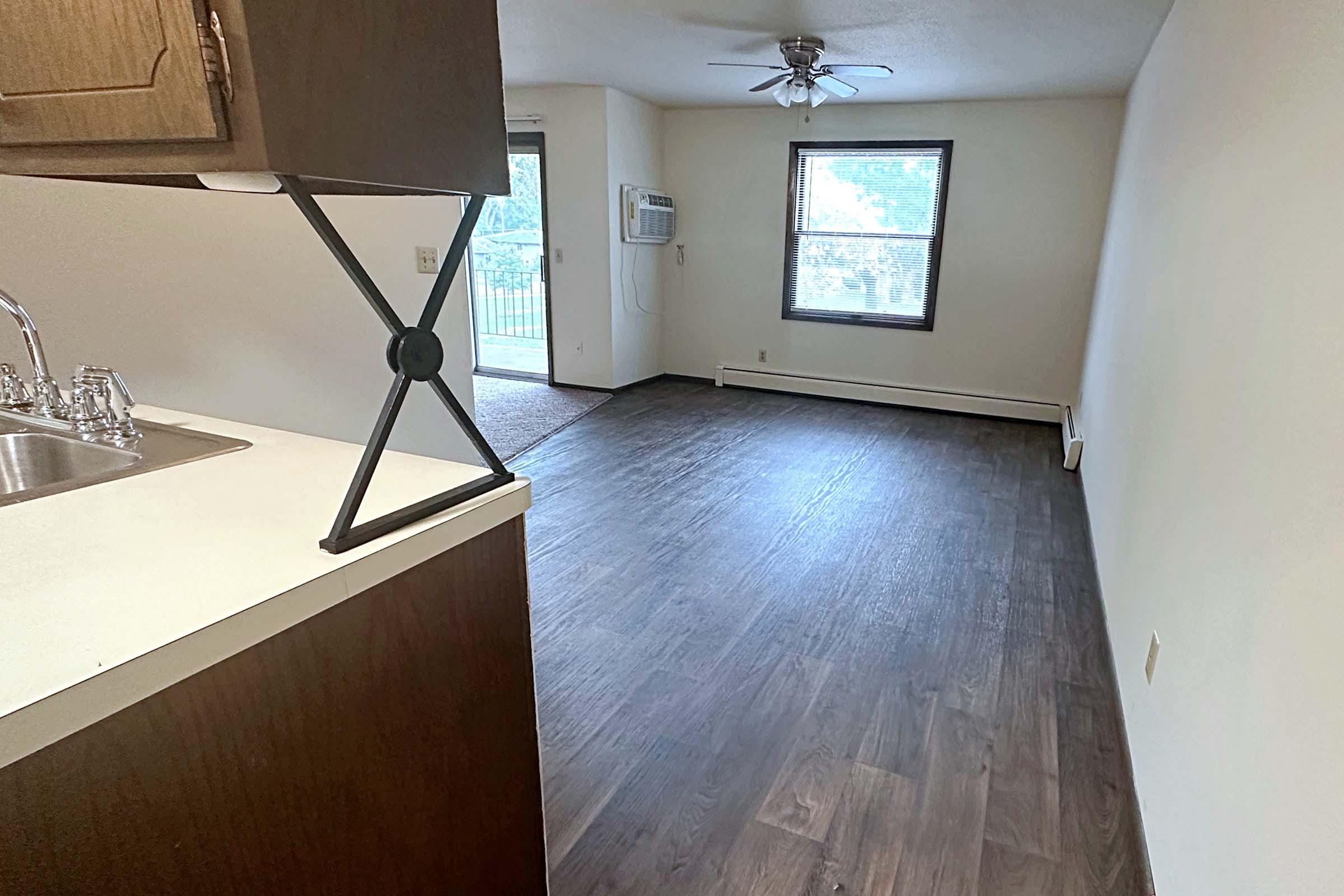 a kitchen with a sink and a mirror