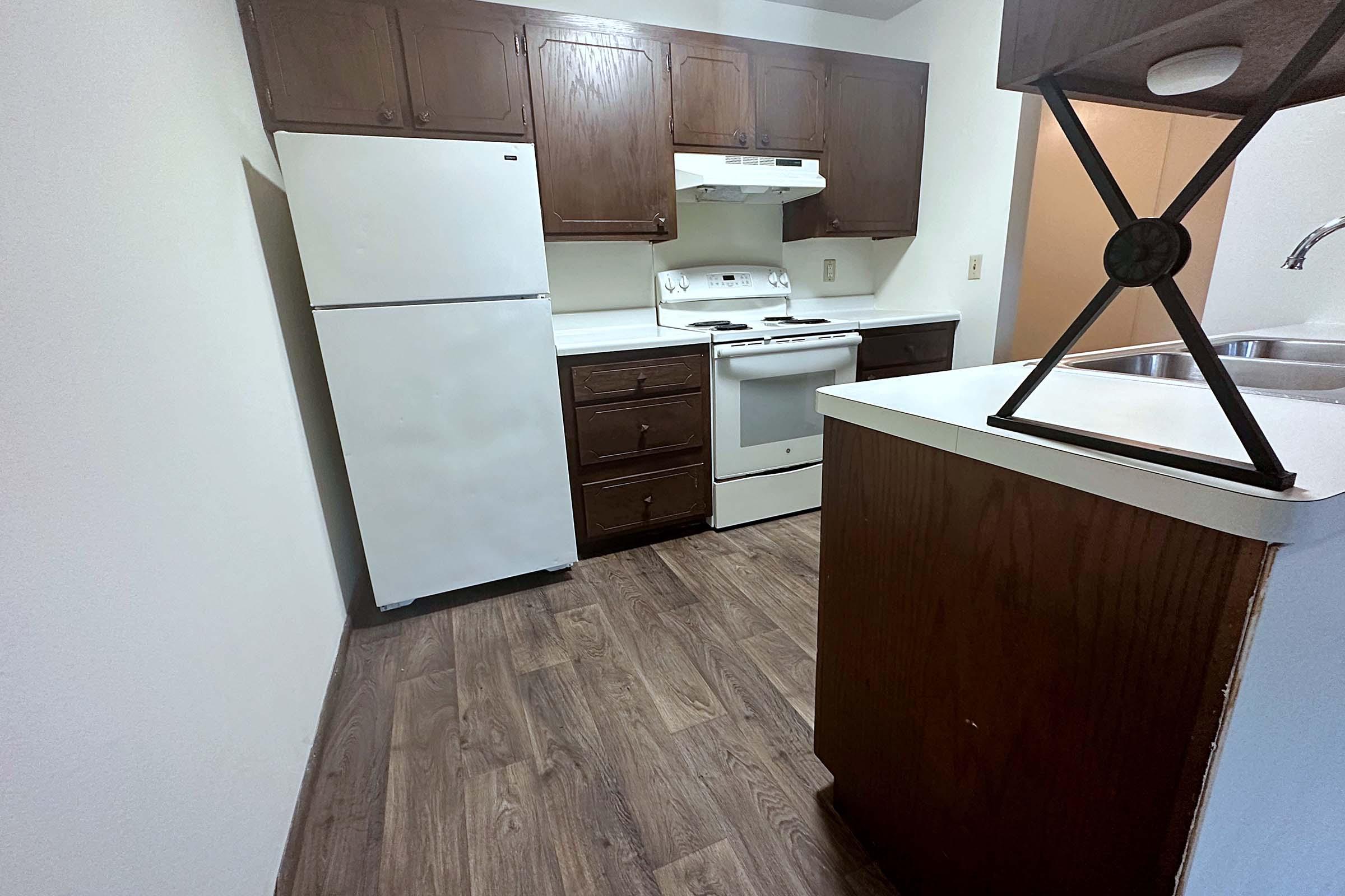 a kitchen with wooden cabinets