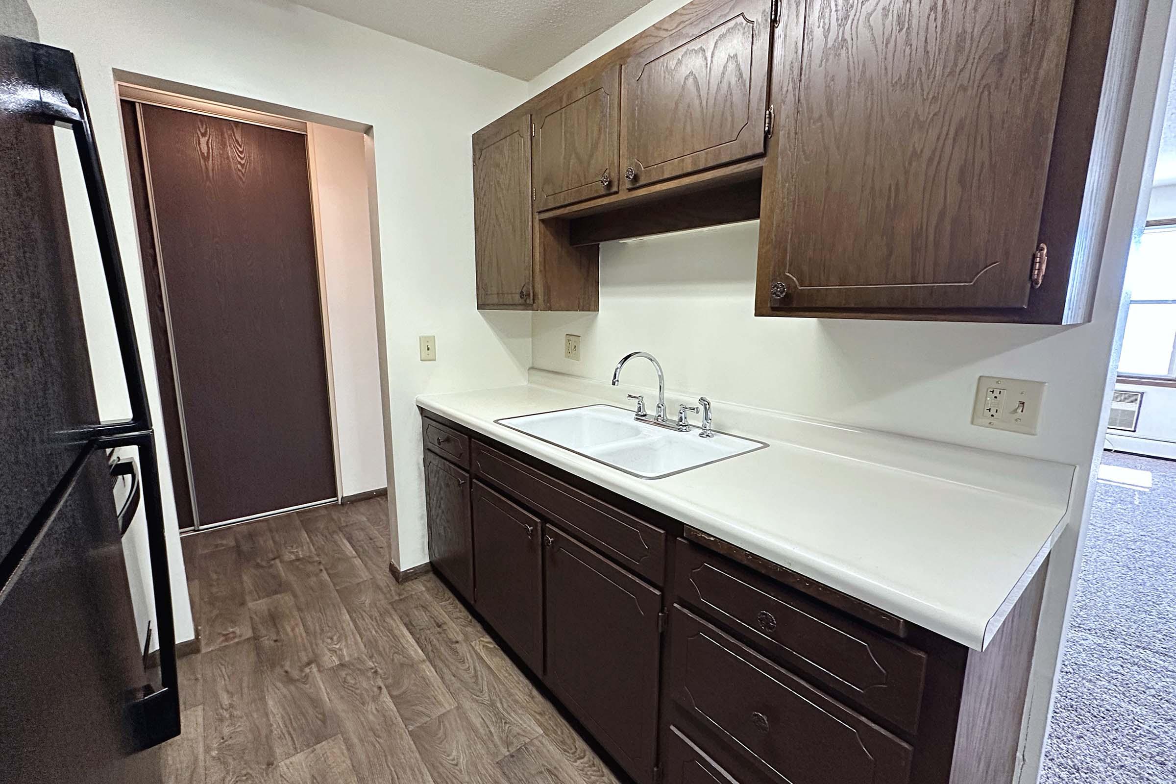 a kitchen with a sink and a mirror