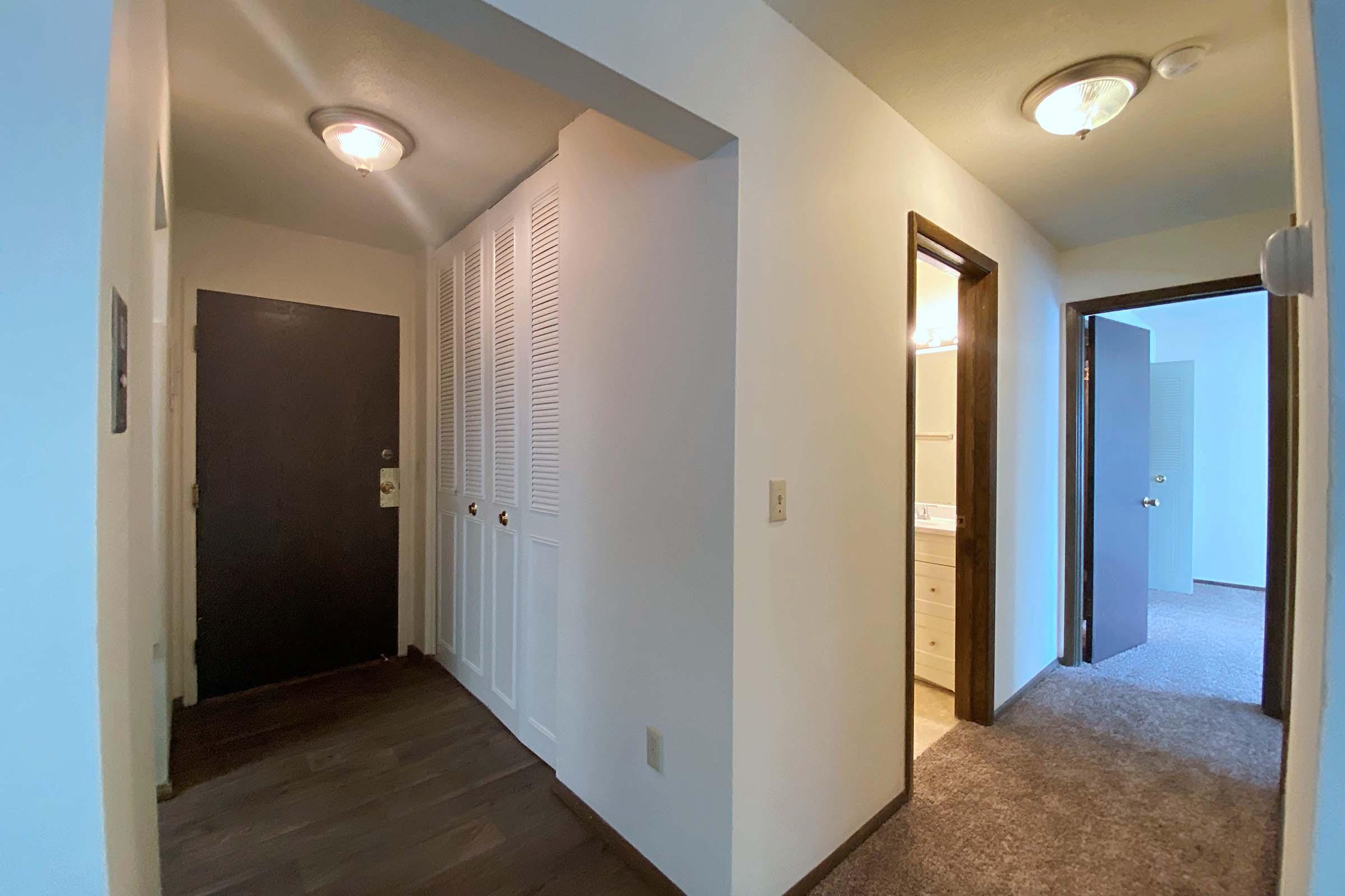 a large empty room with a sink and a mirror