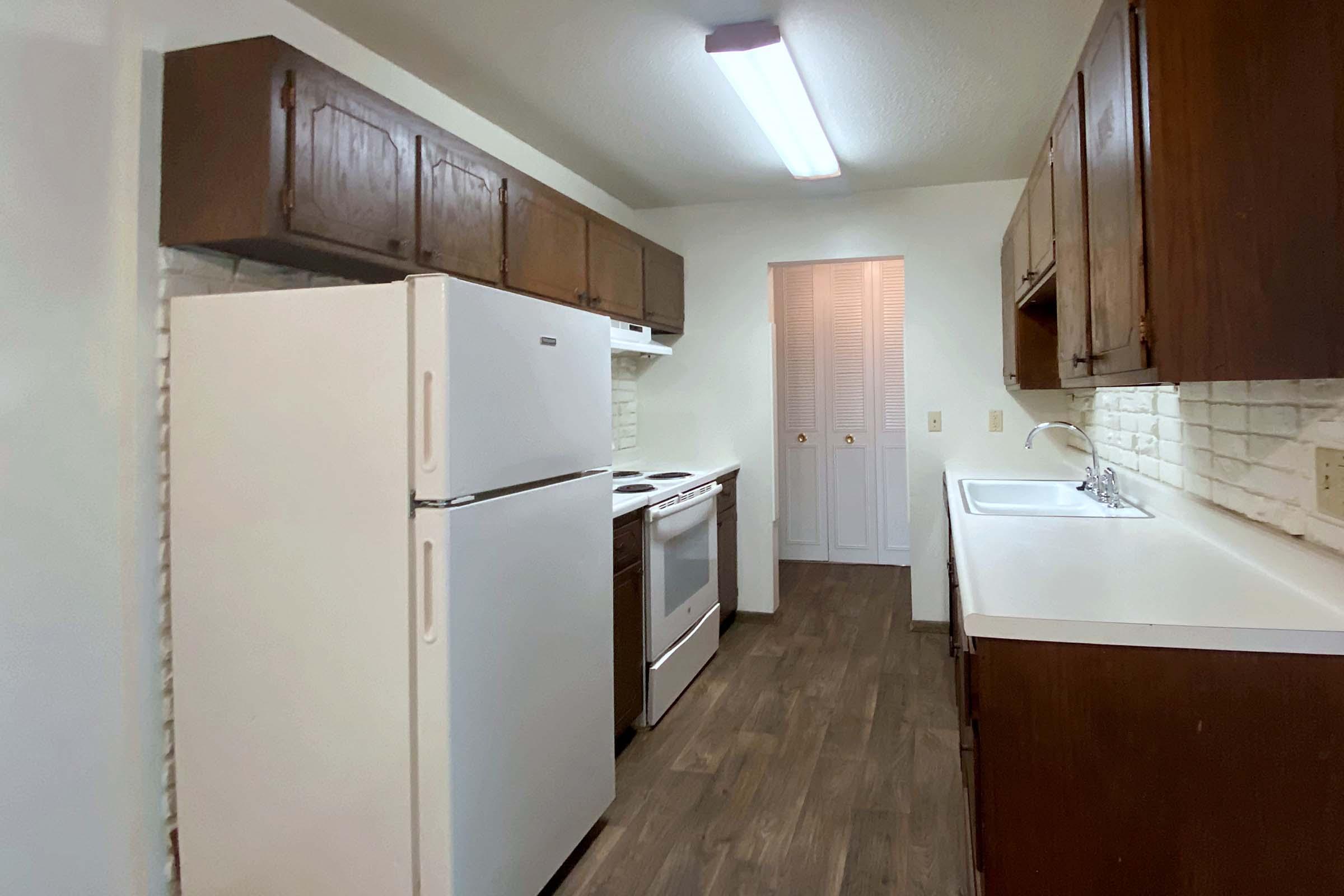 a kitchen with a stove and a refrigerator