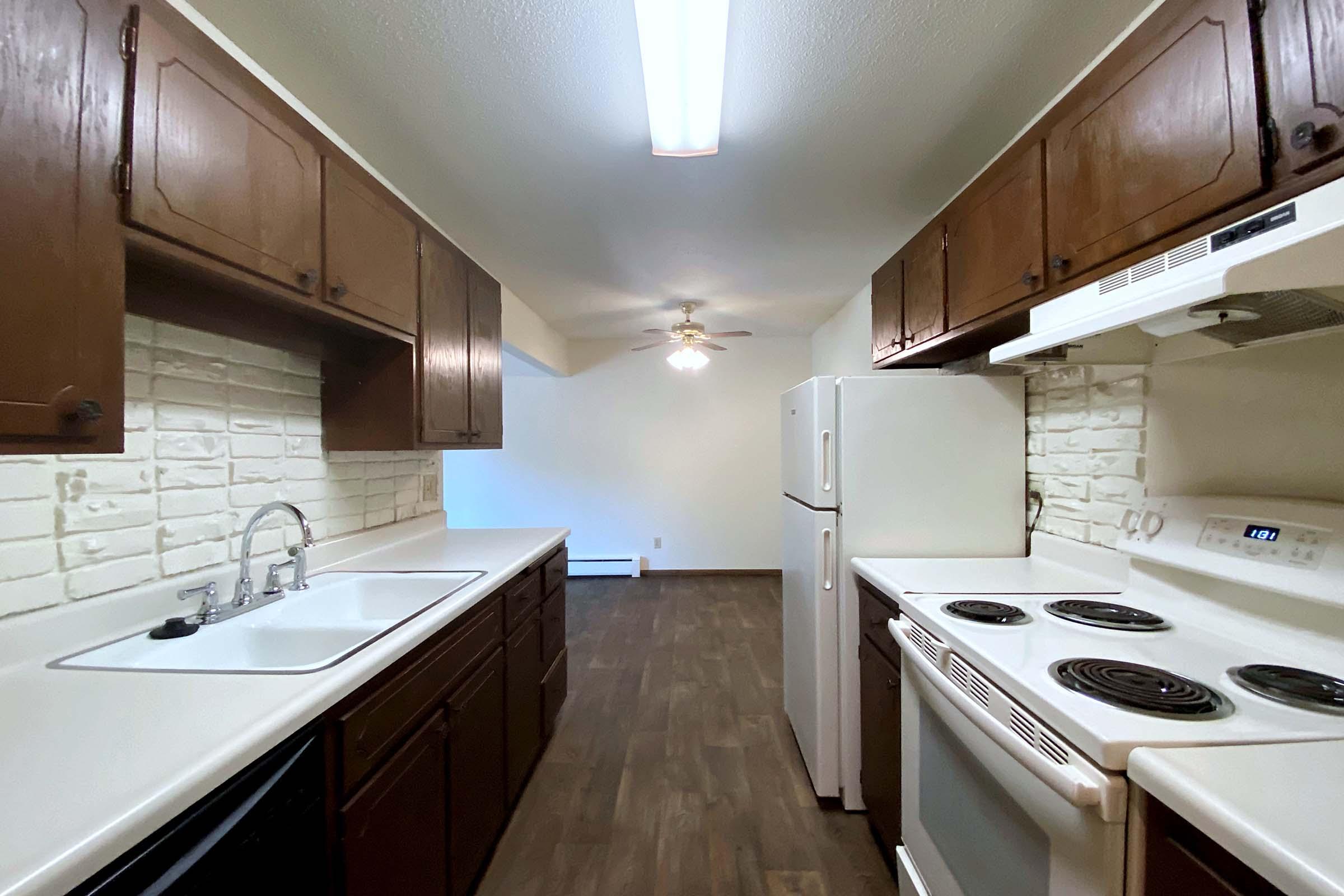 a kitchen with a sink and a stove top oven