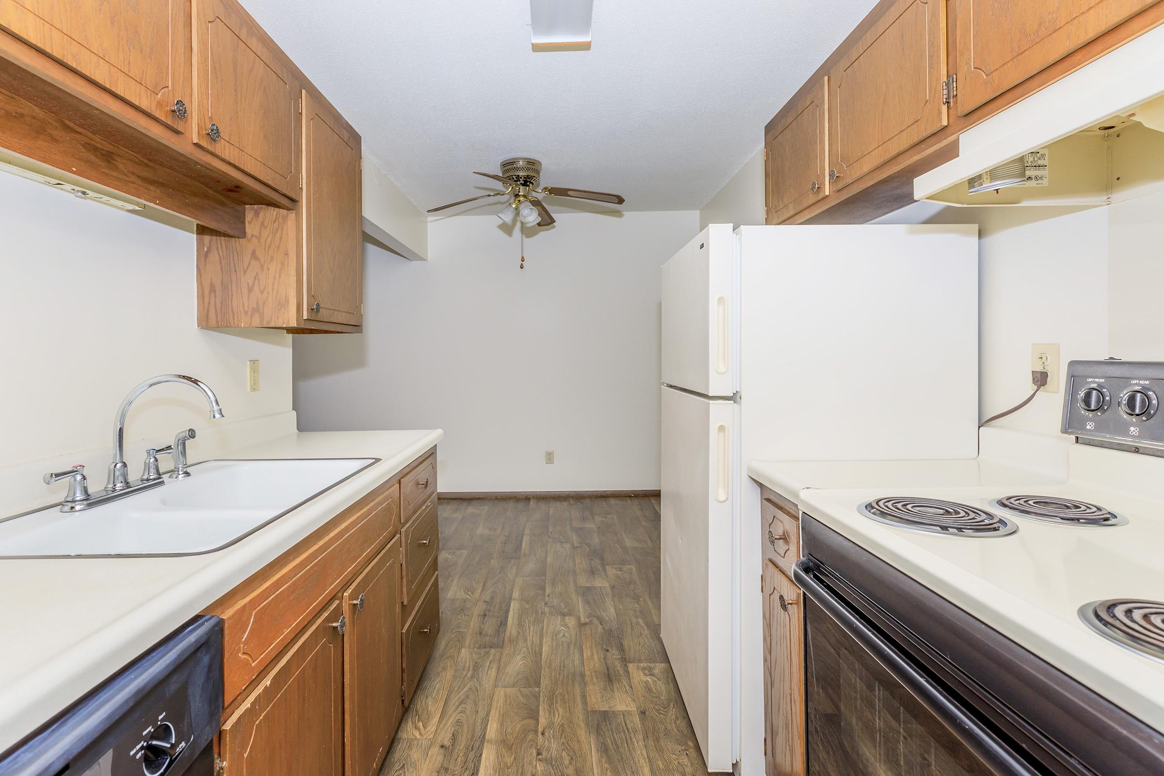 a kitchen with a stove and a refrigerator