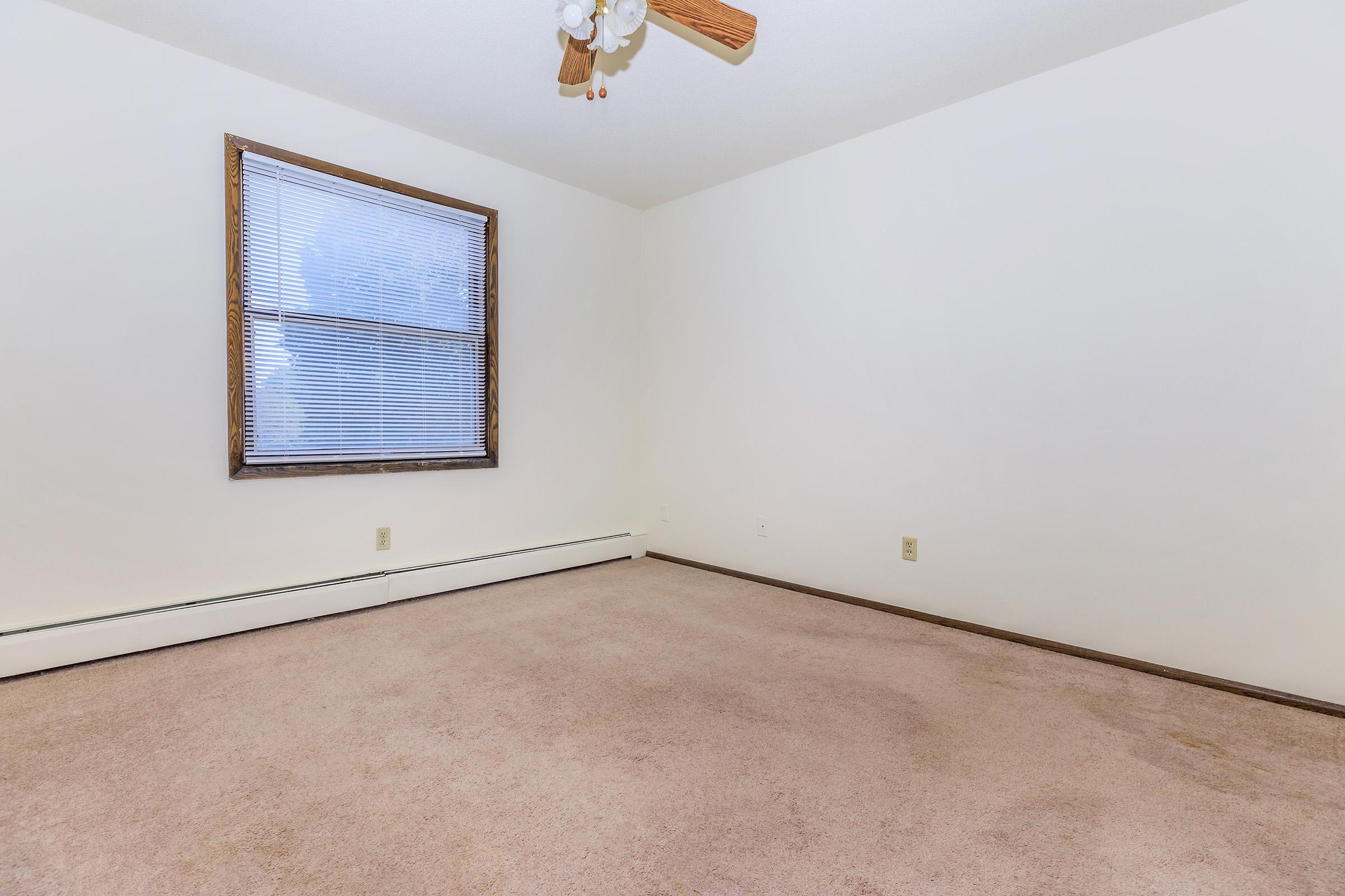 a bedroom with a building in the background