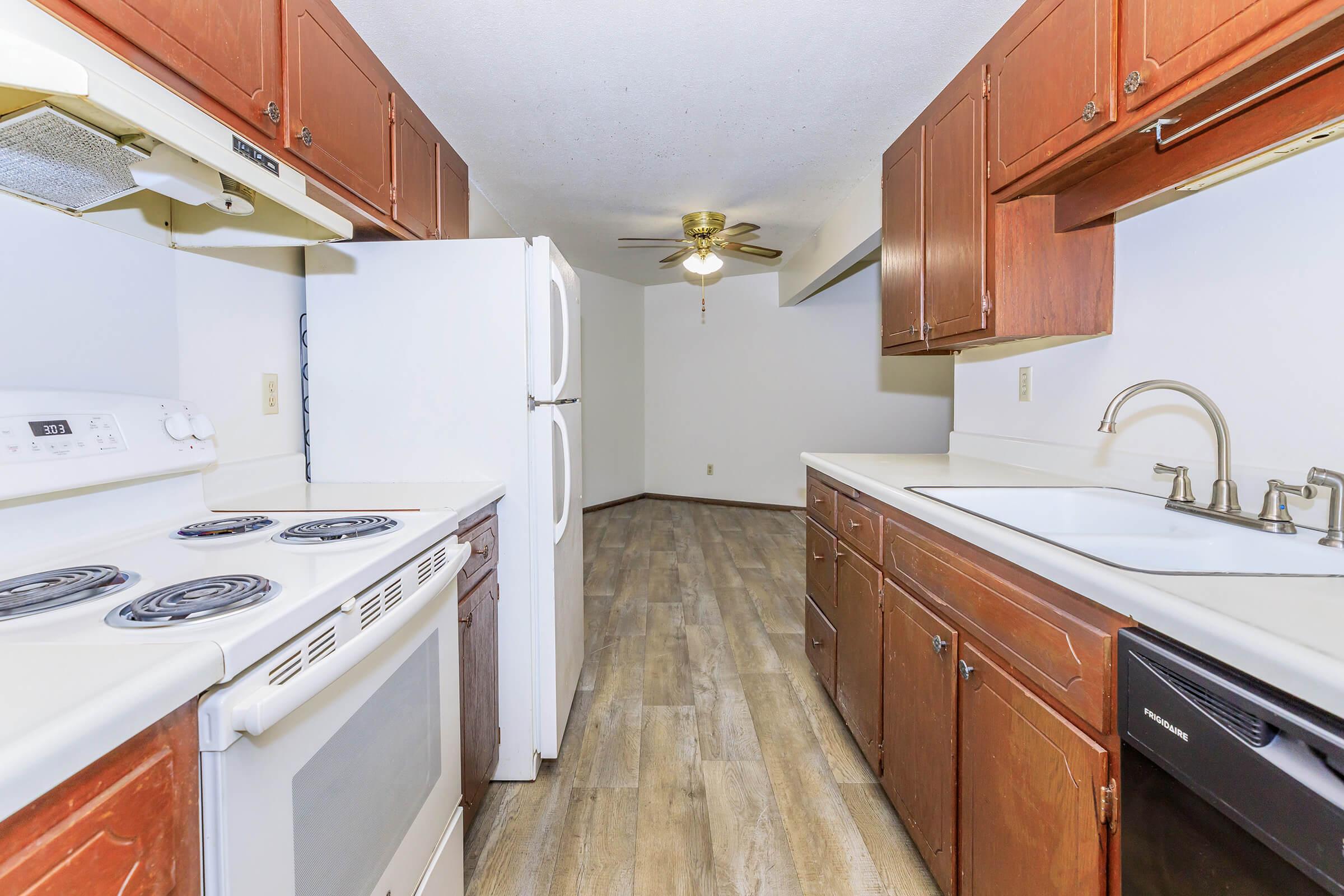 a kitchen with a stove and a refrigerator