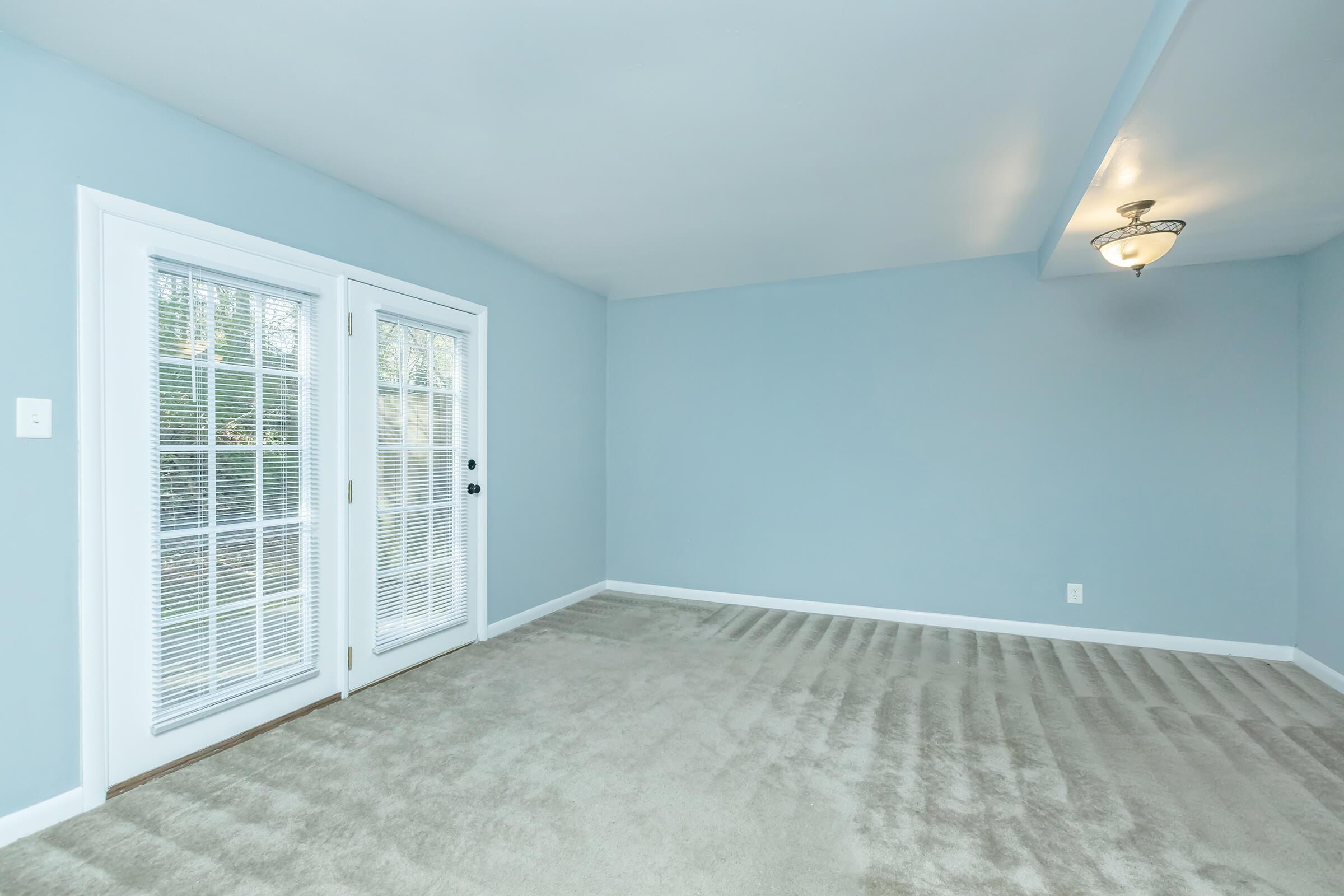 a bedroom with a large window