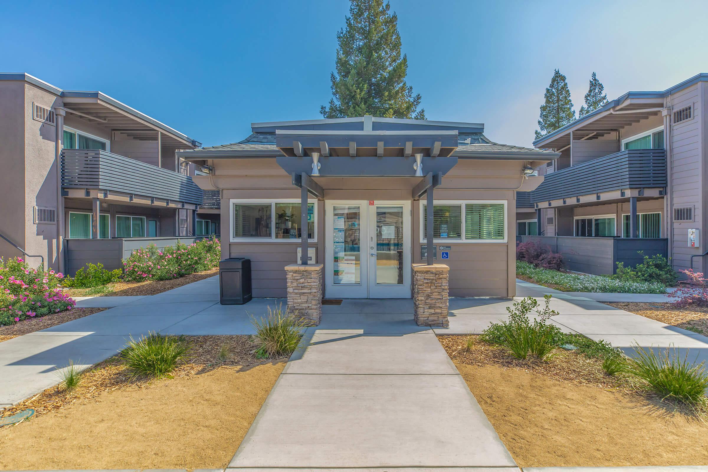 Community leasing office surrounded by apartment buildings.