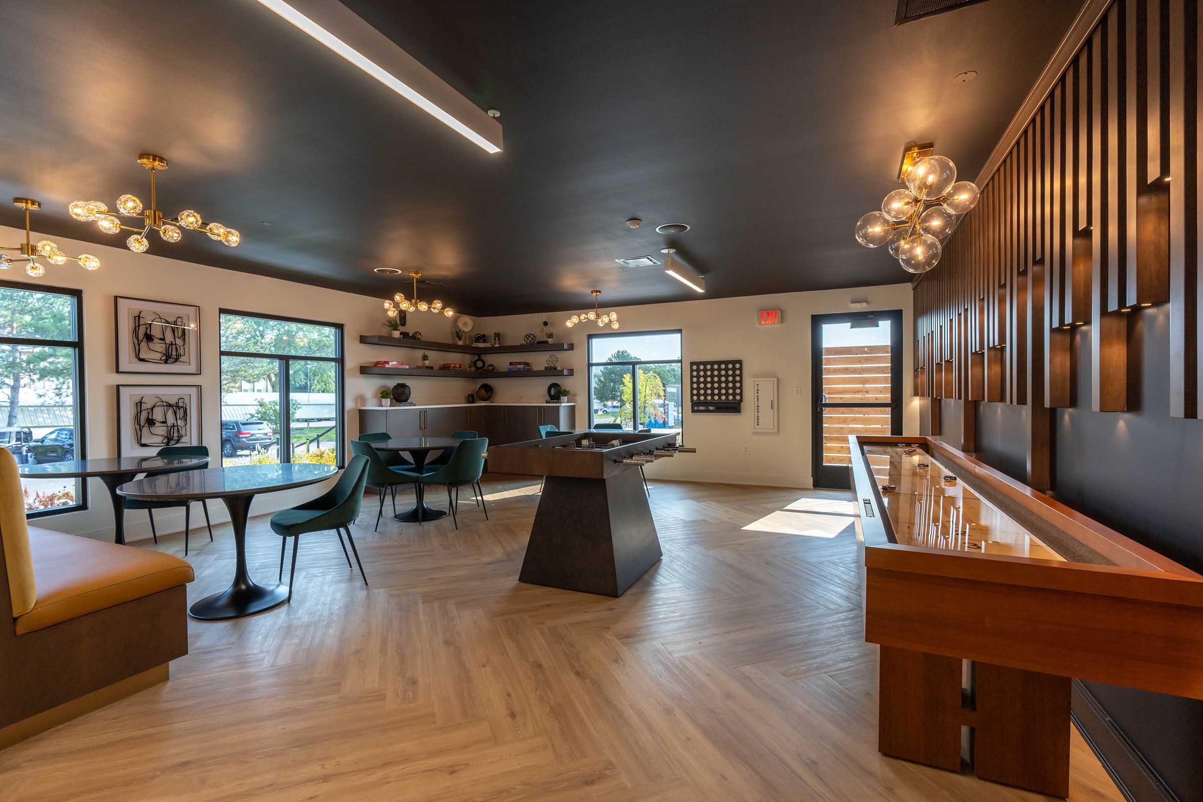 a living room filled with furniture on top of a hard wood floor