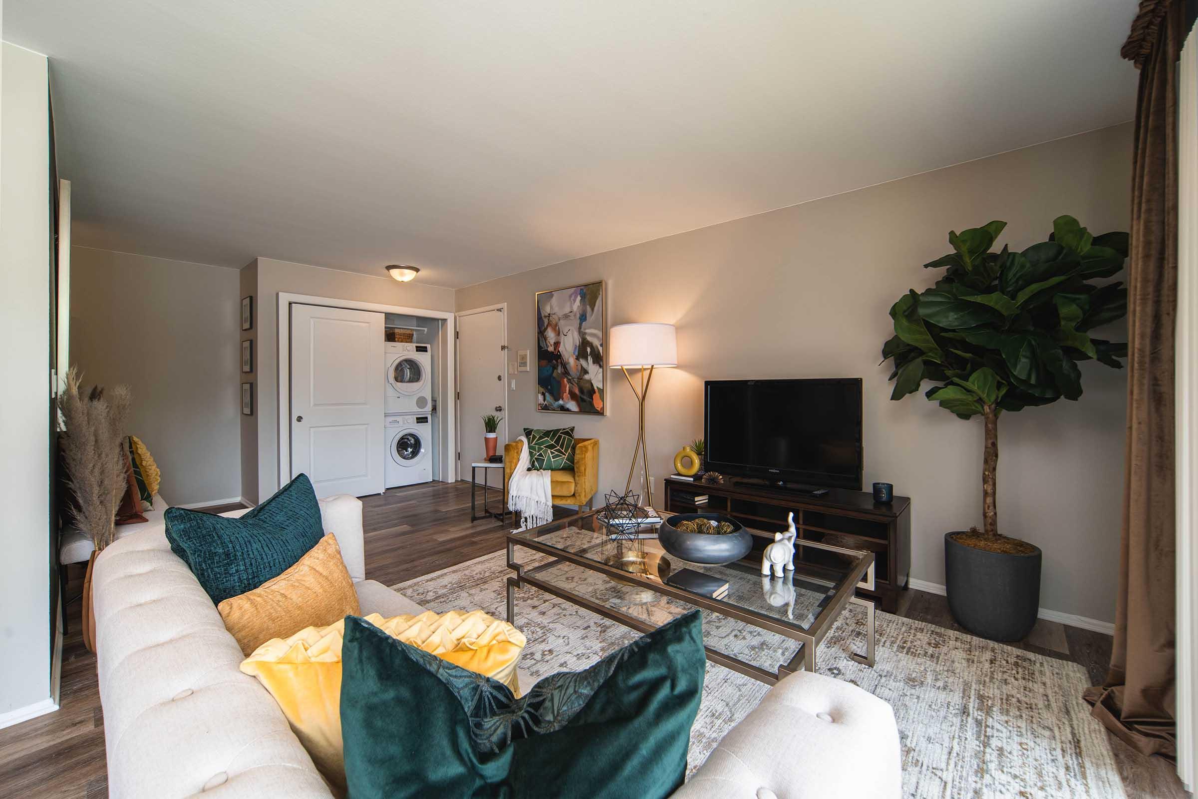 a living room filled with furniture and a flat screen tv