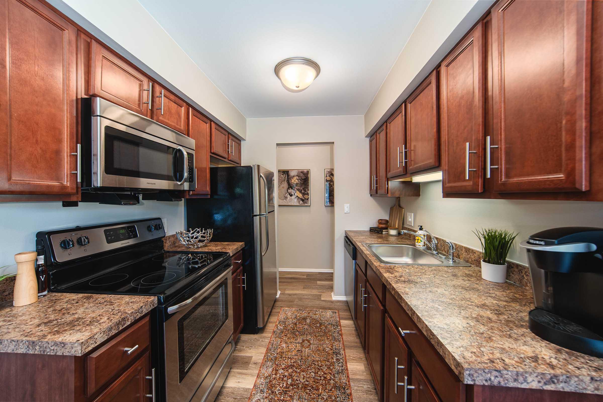 a modern kitchen with stainless steel appliances and wooden cabinets